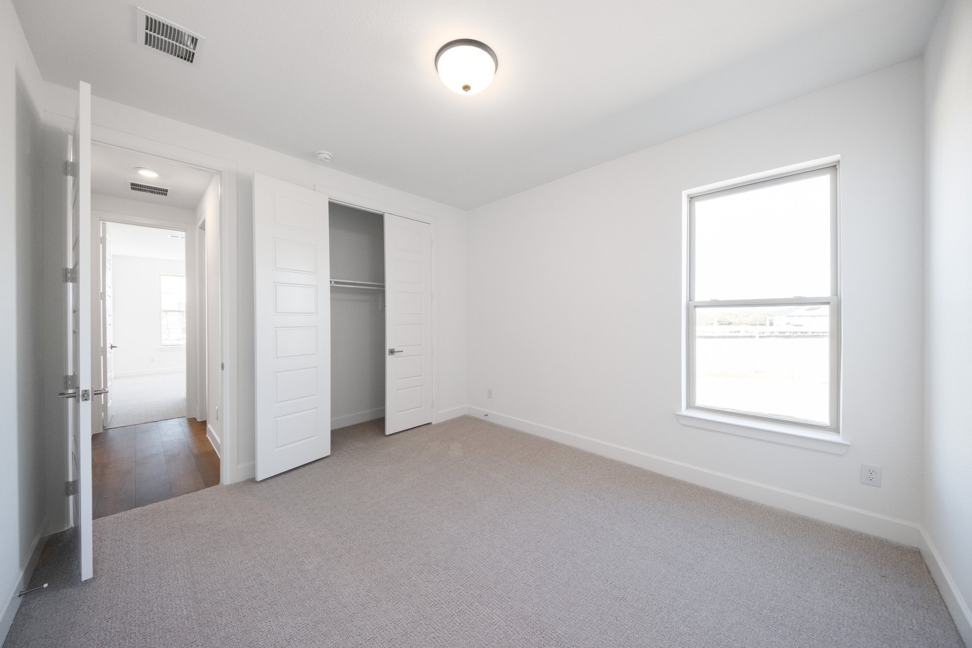 bedroom with a window and carpet 