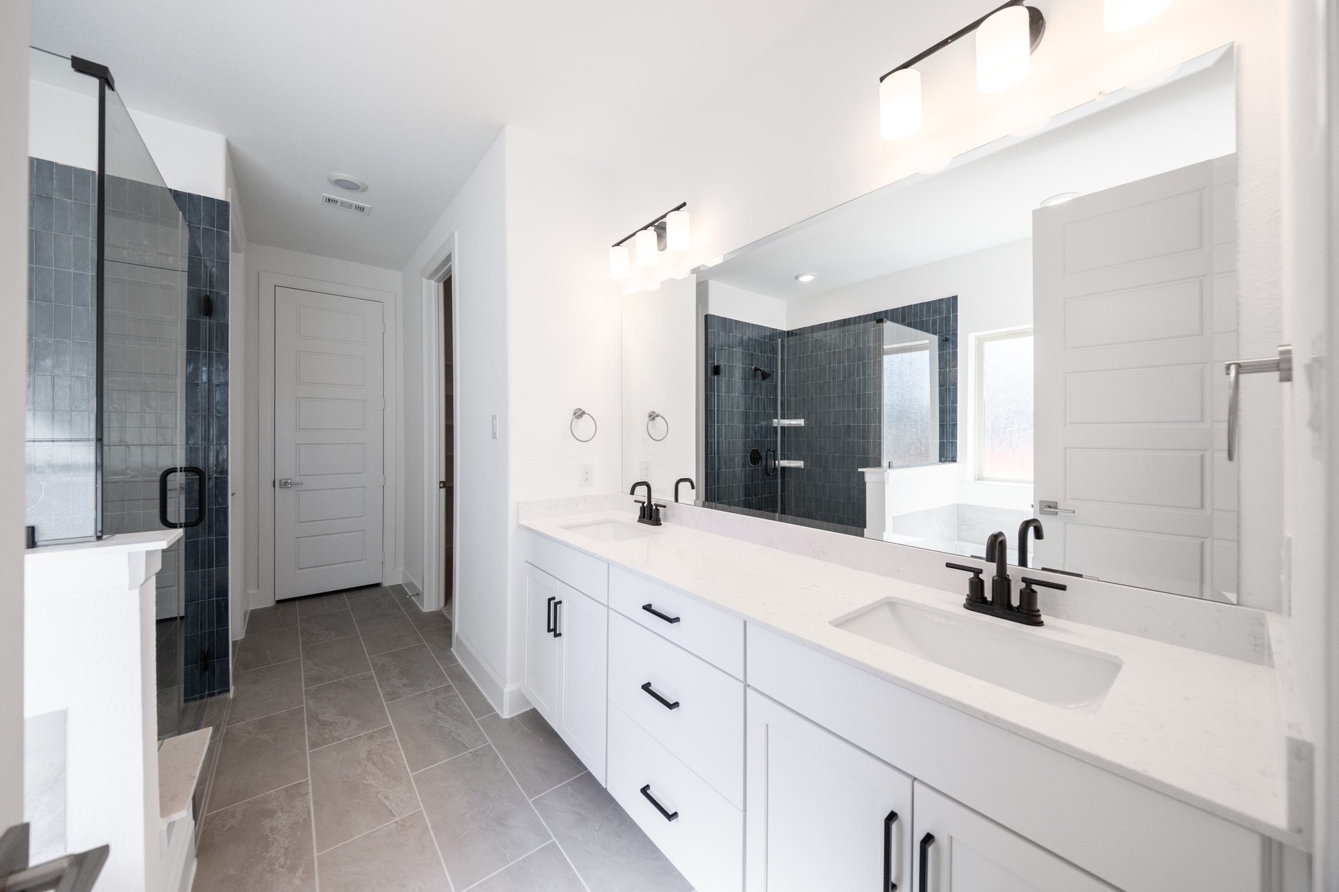 bathroom with white countertops and white cabinets 