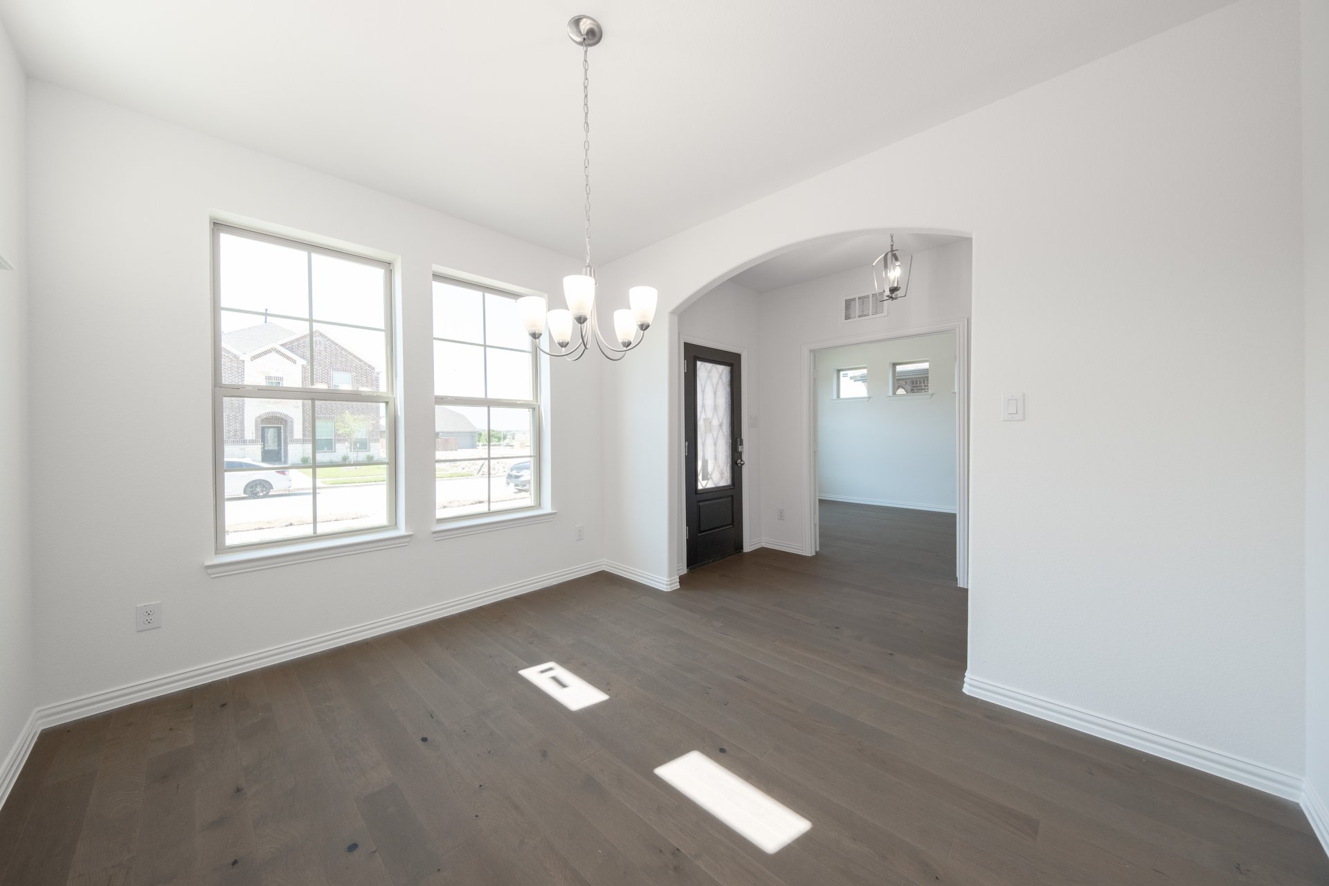dining room with large windows and chandelier 