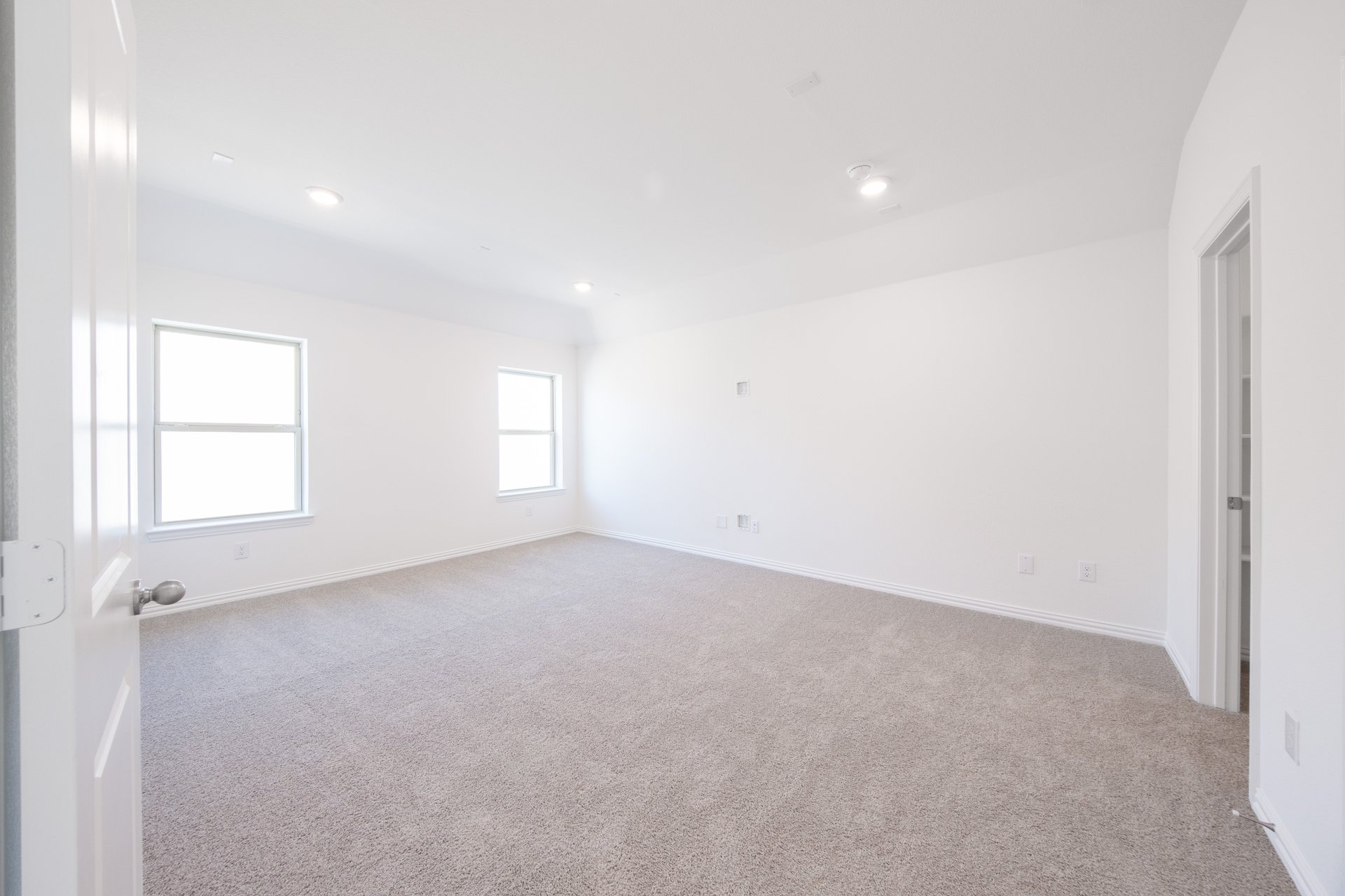 media room with windows and carpet 