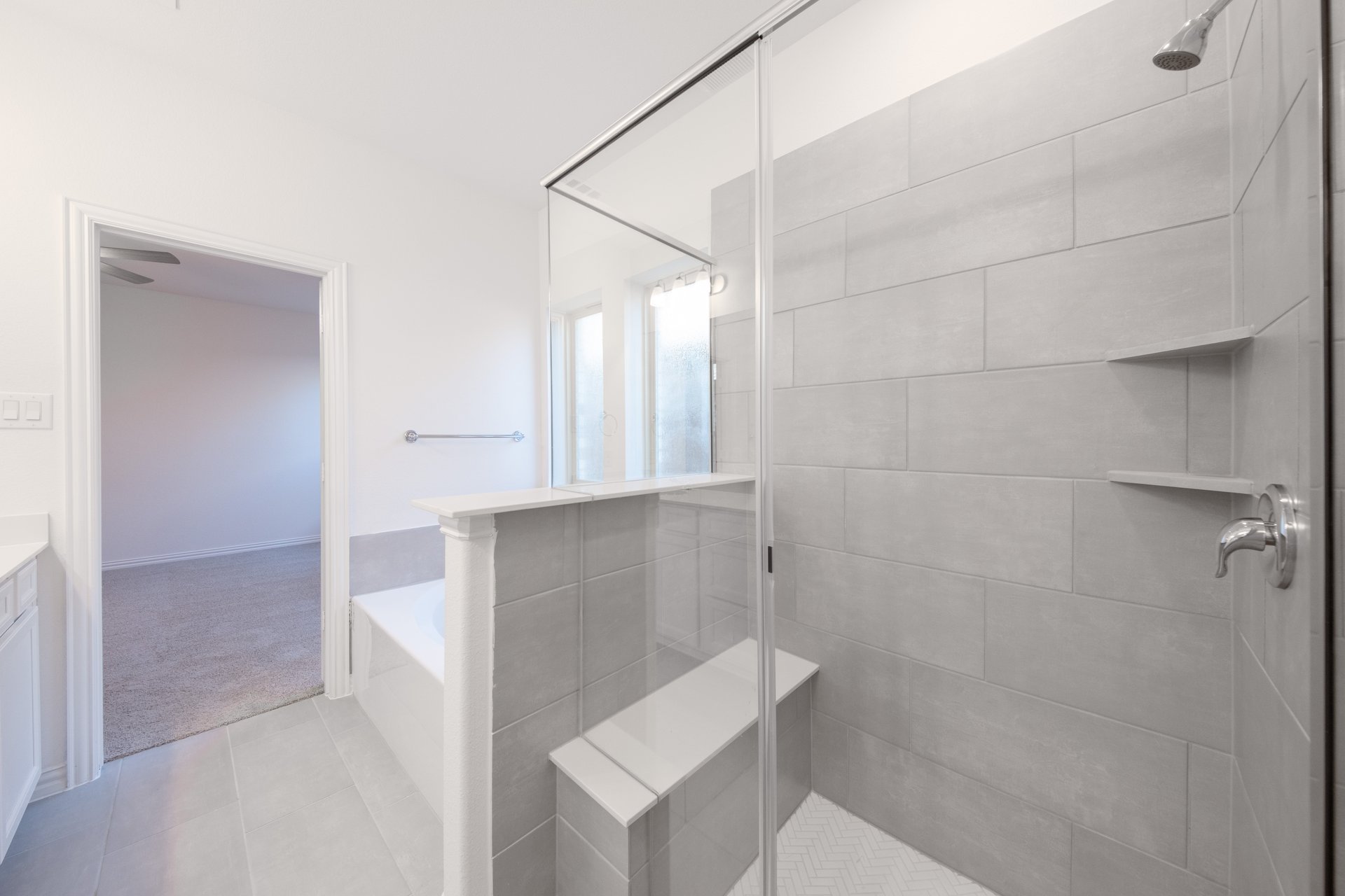 bathroom with walk-in shower and tile 