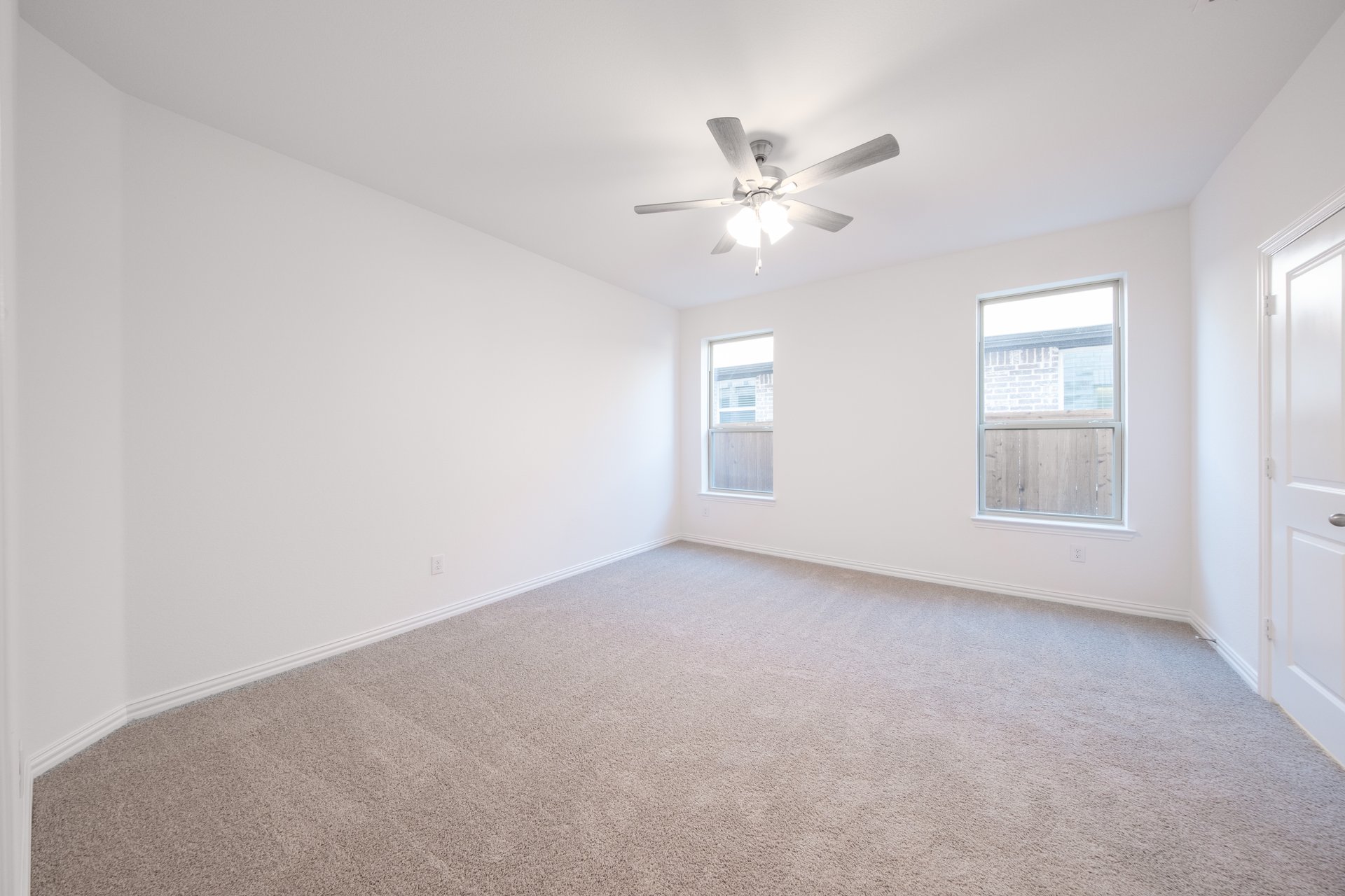 bedroom with windows and carpet 