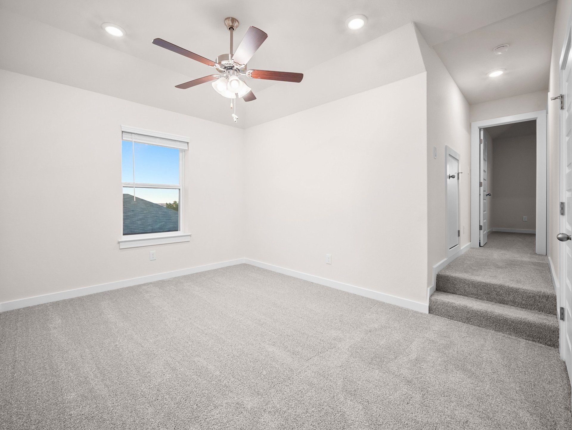 loft with carpet, window & ceiling fan