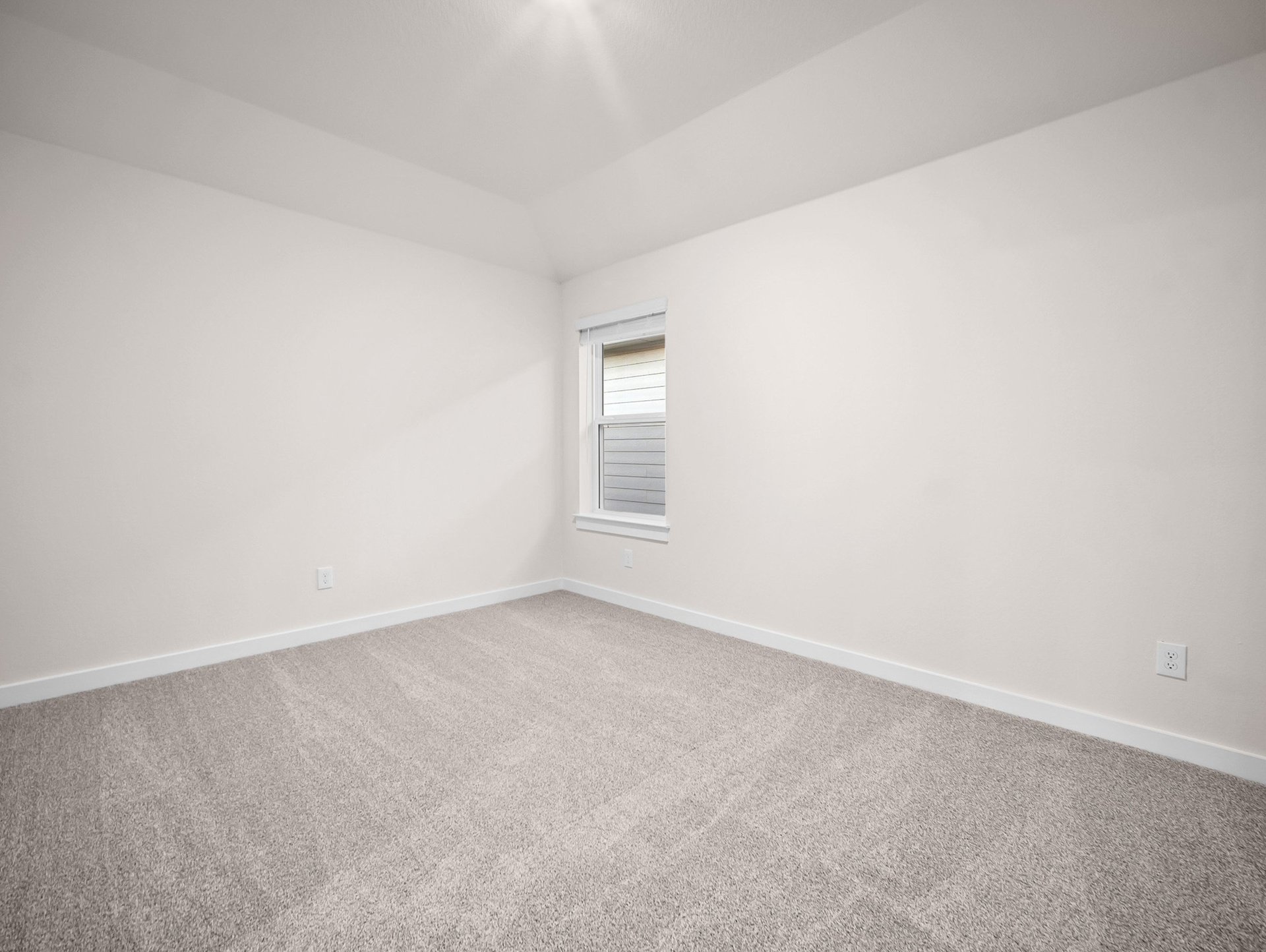bedroom with carpet, sloped ceiling & a window