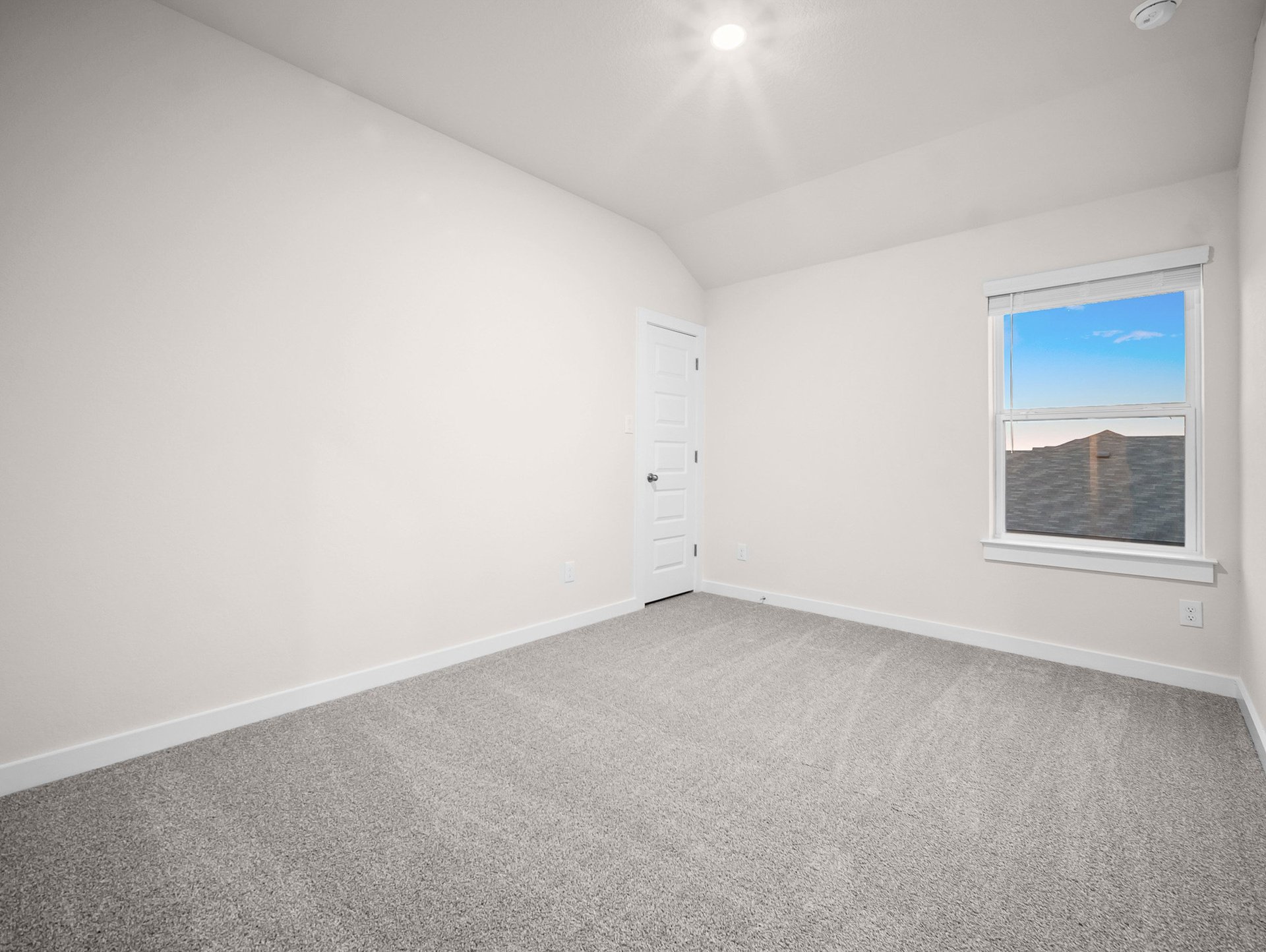 bedroom with carpet, sloped ceiling & a window