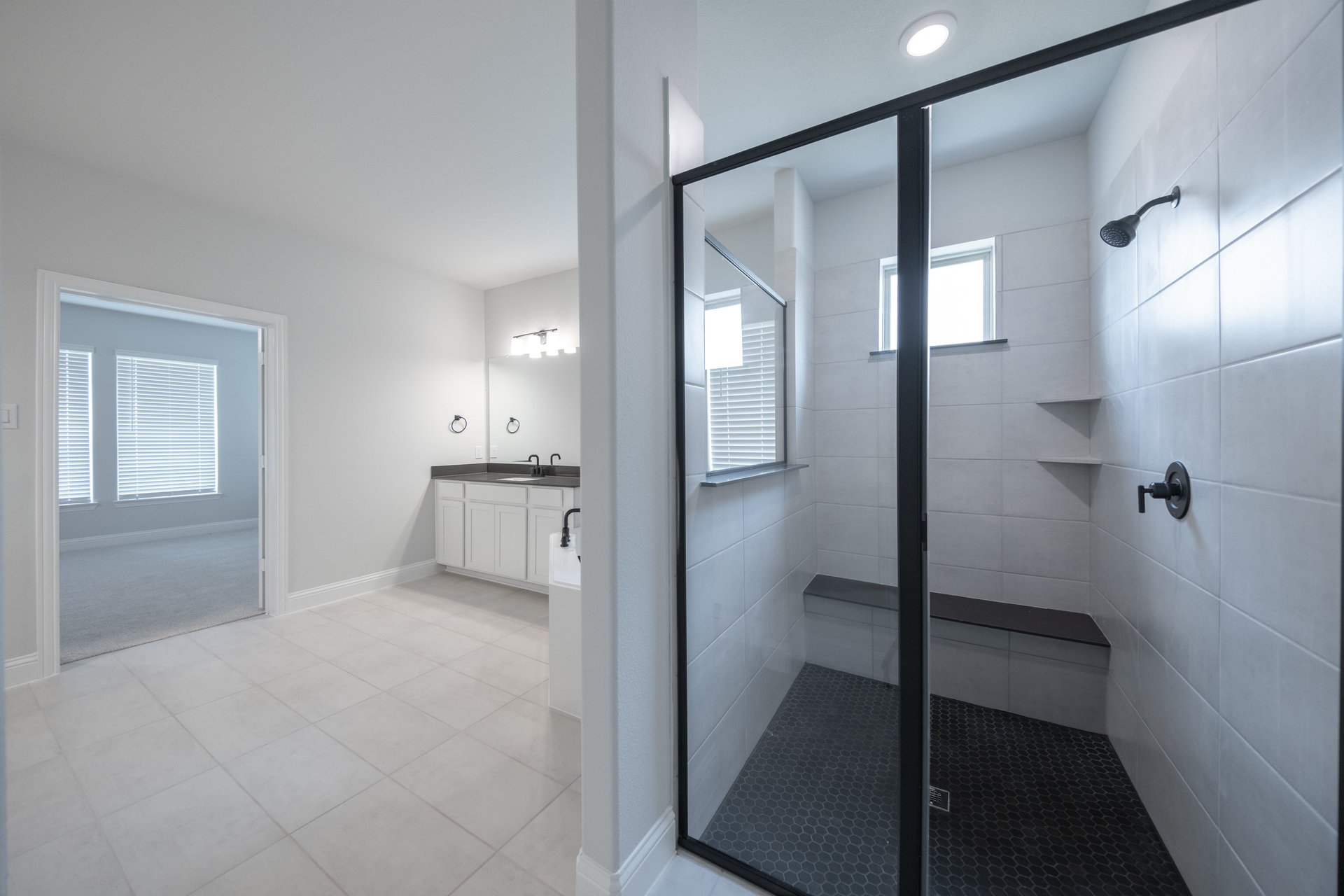spacious primary bathroom with walk-in shower
