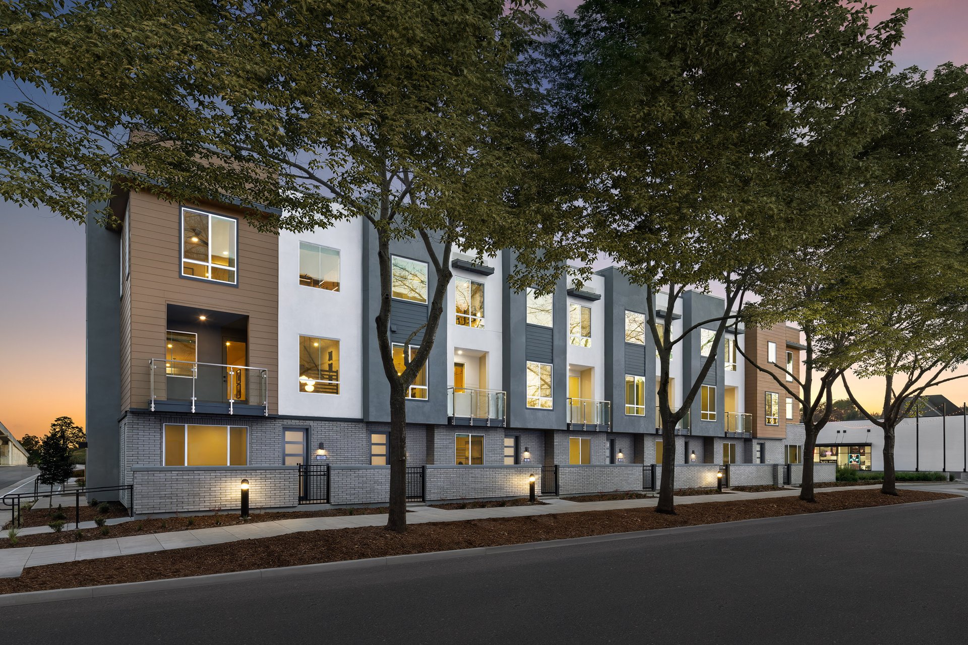 front exterior of modern gray 3-story townhome building