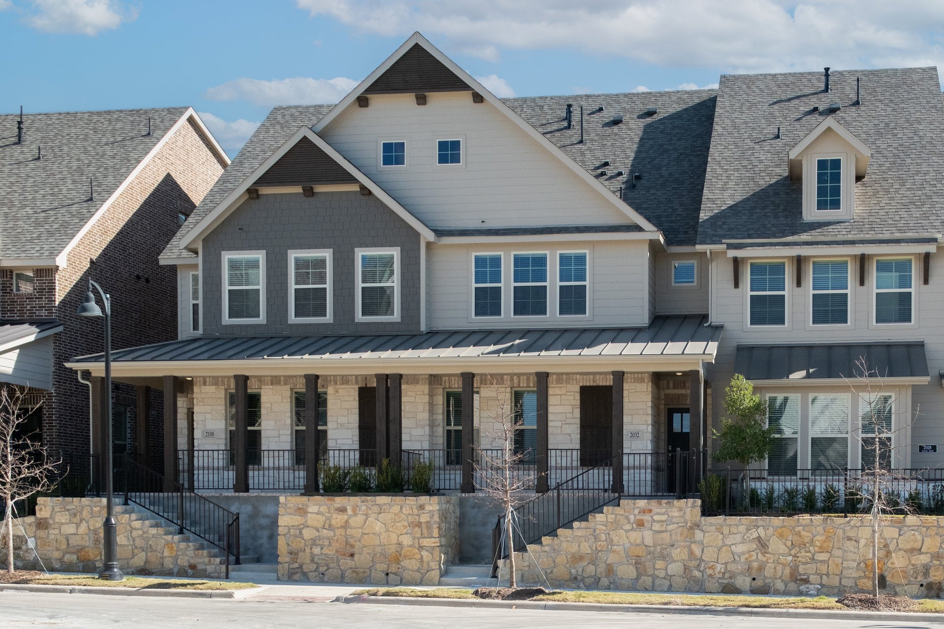 townhouse exterior with stone and landscaping 