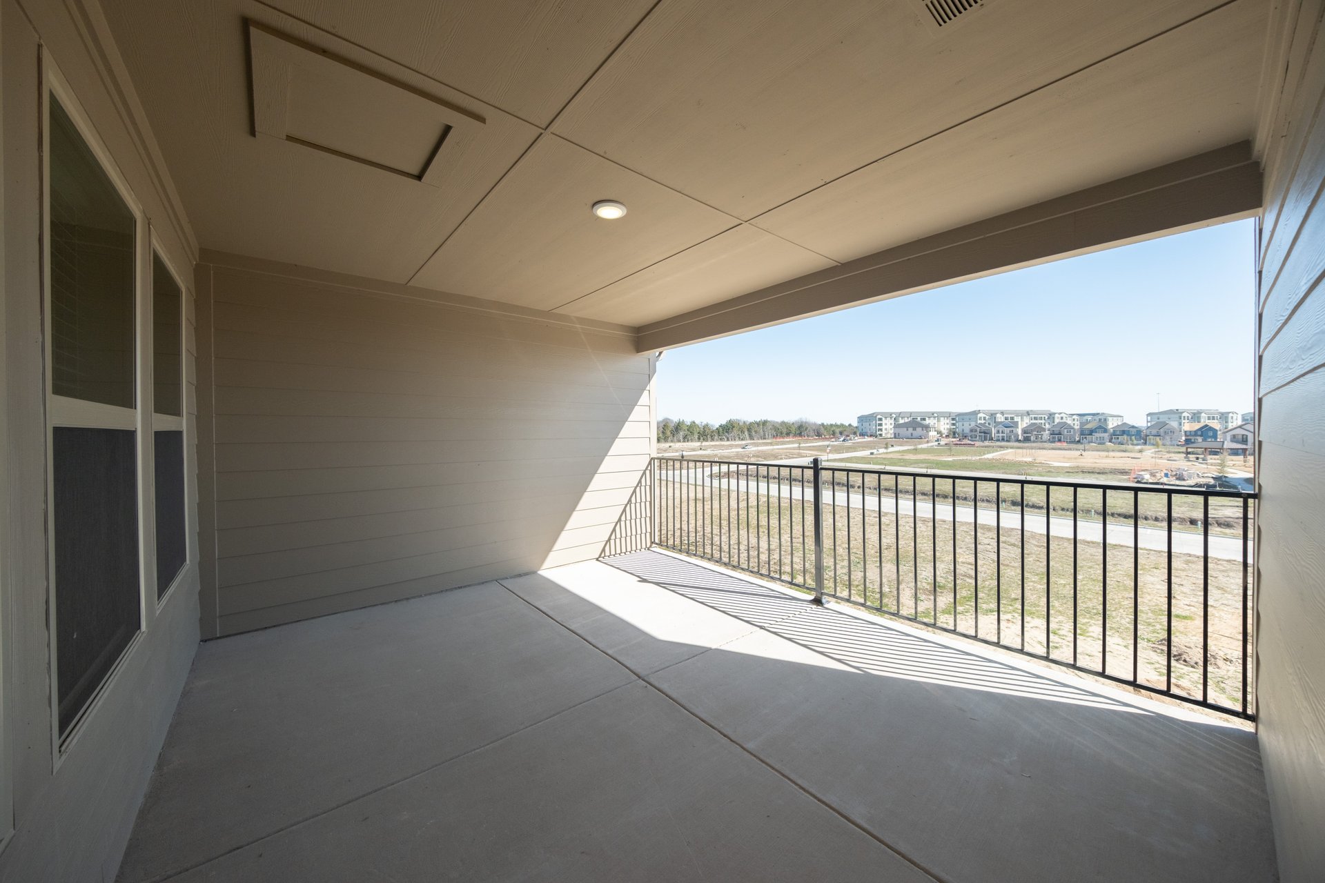 terrace with iron railing overlooking grassy area 
