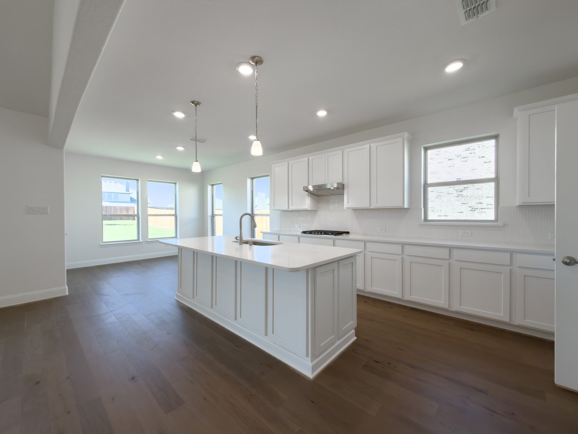open kitchen with white cabinets and countertops