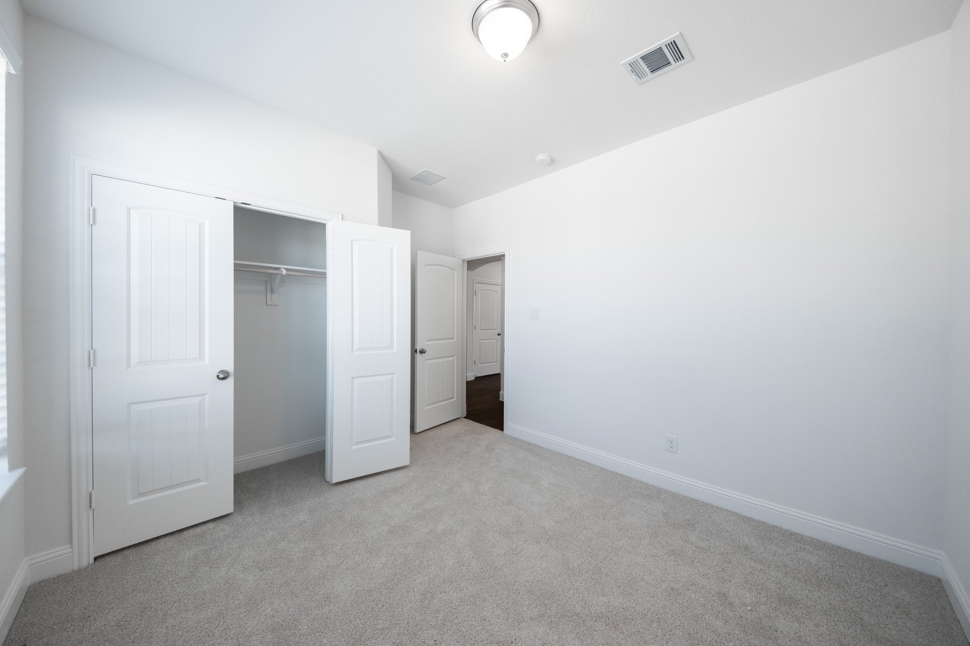 bedroom with carpet and closet with double doors 