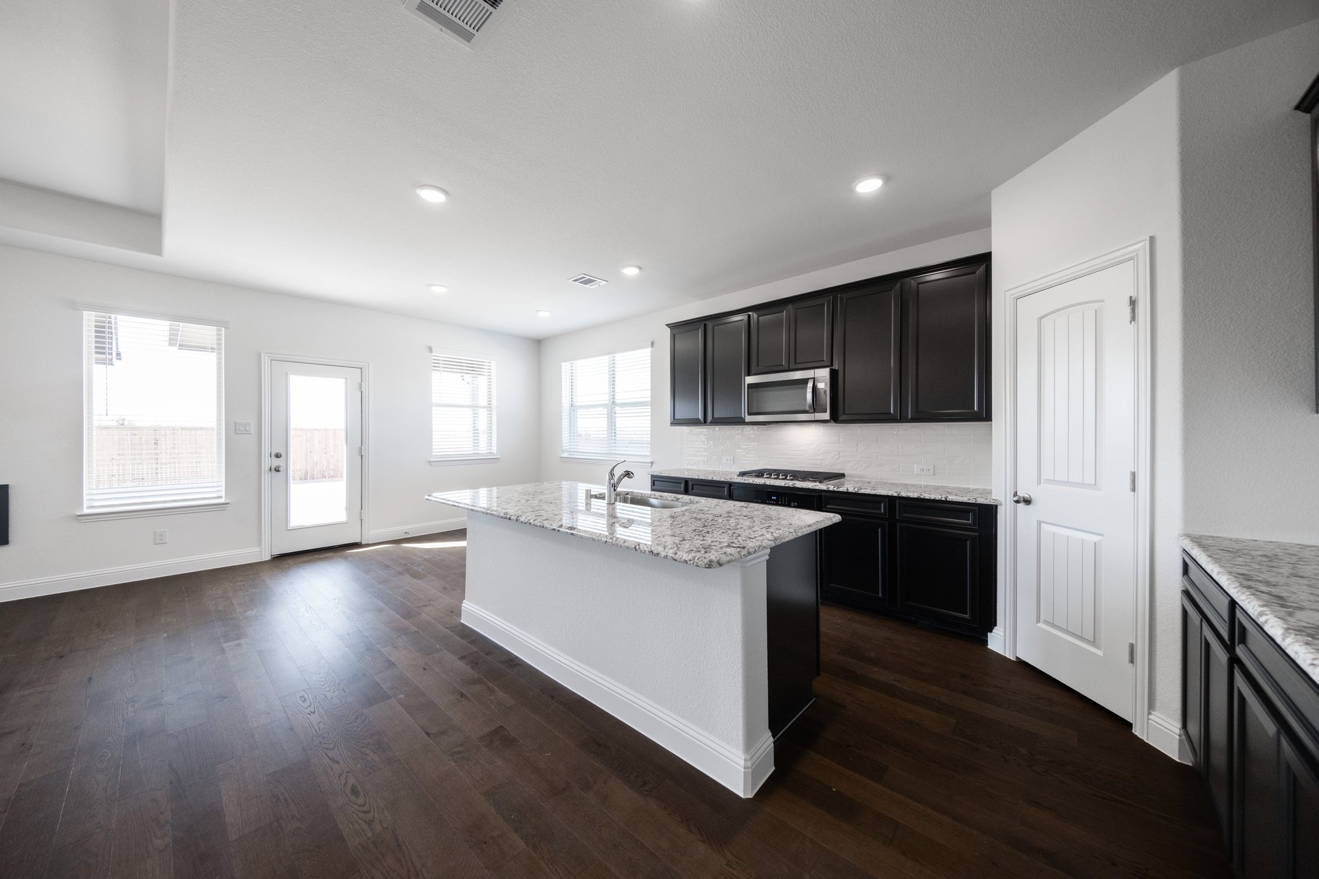 kitchen with large island and dark cabinets 