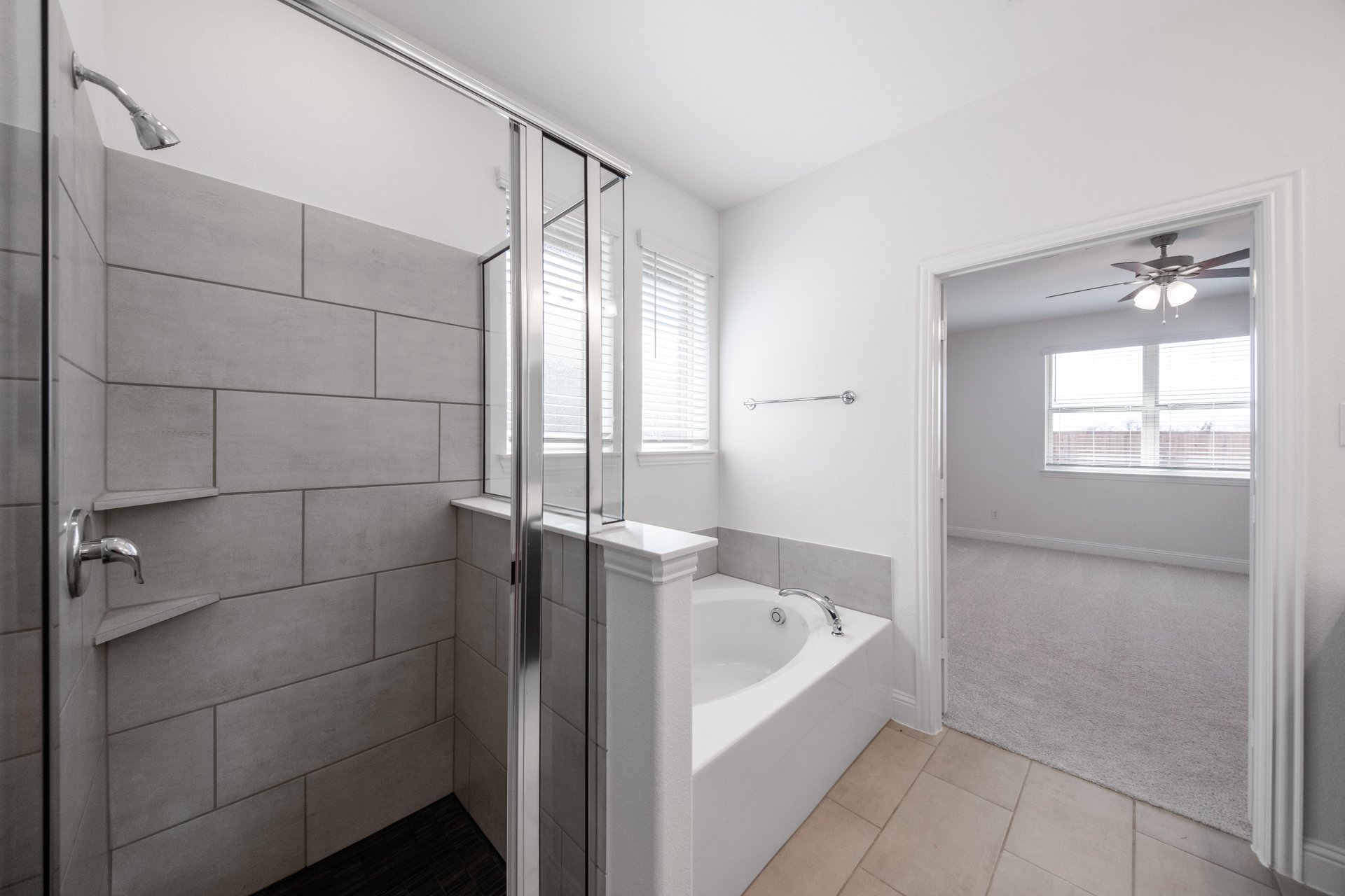 bathroom with large tub and walk-in shower
