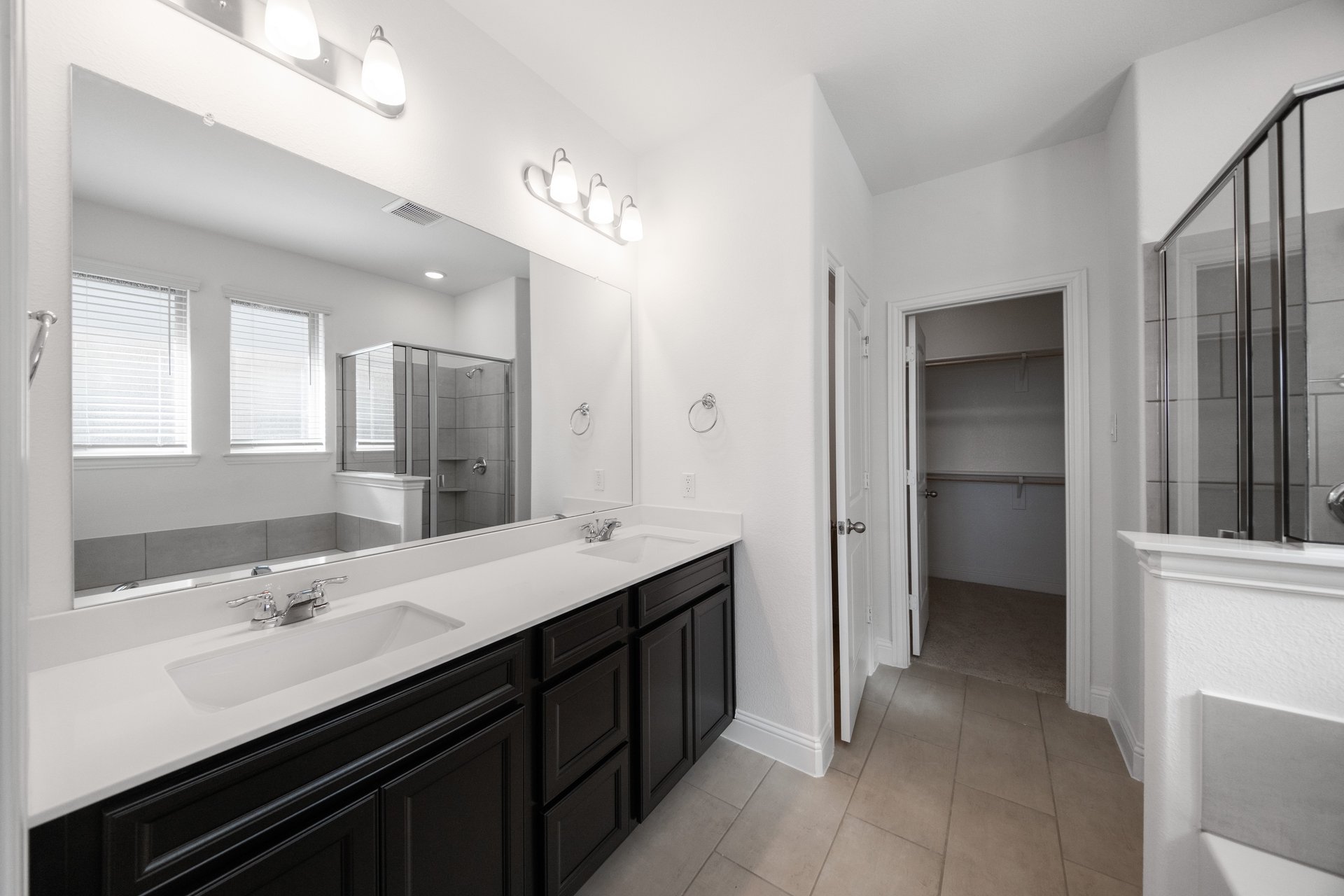 bathroom with dark cabinets and white countertops 