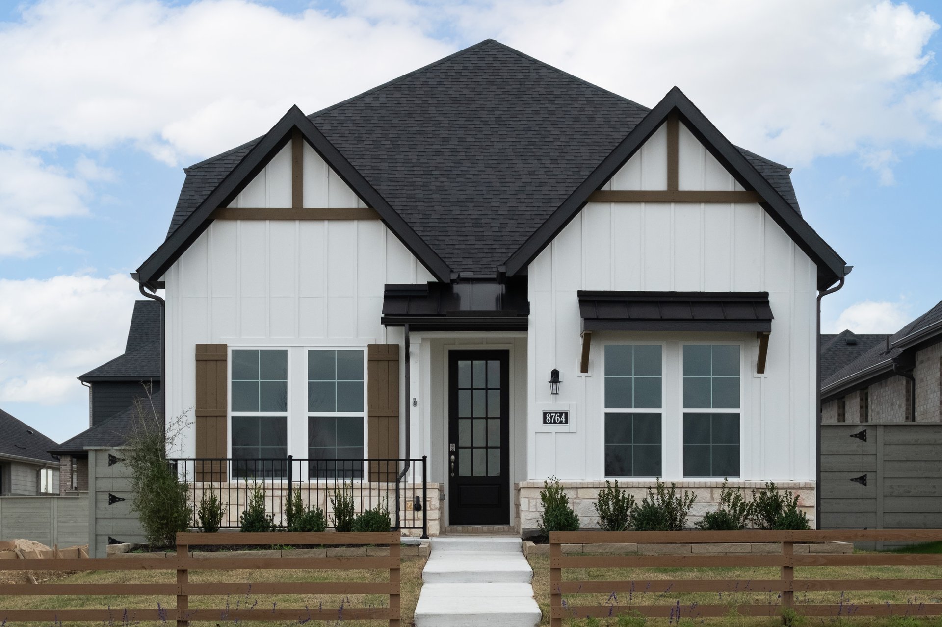 white home exterior with fence and landscaping