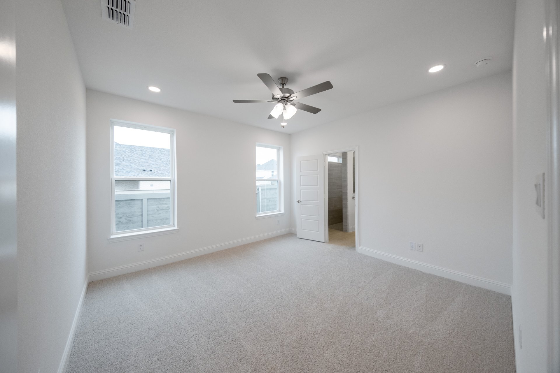 bedroom with two windows and carpet