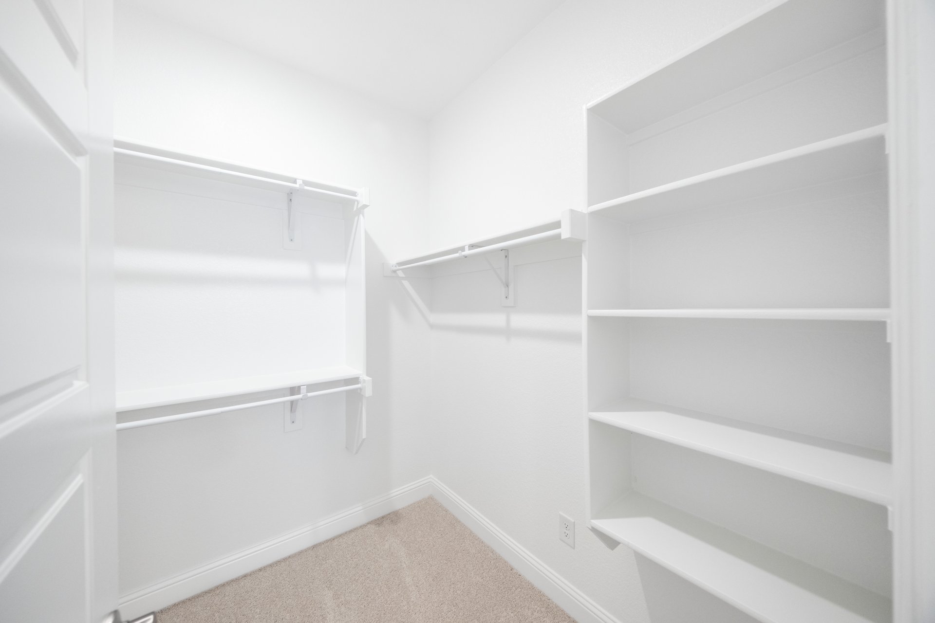 closet with hanging racks and shelves