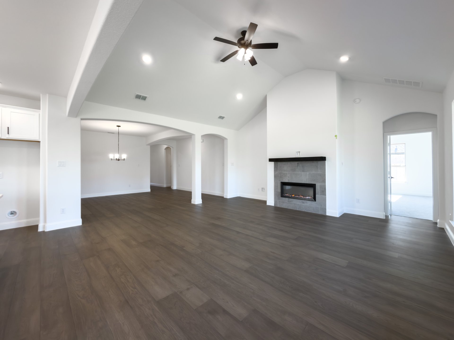 open great room with wood floors and fireplace