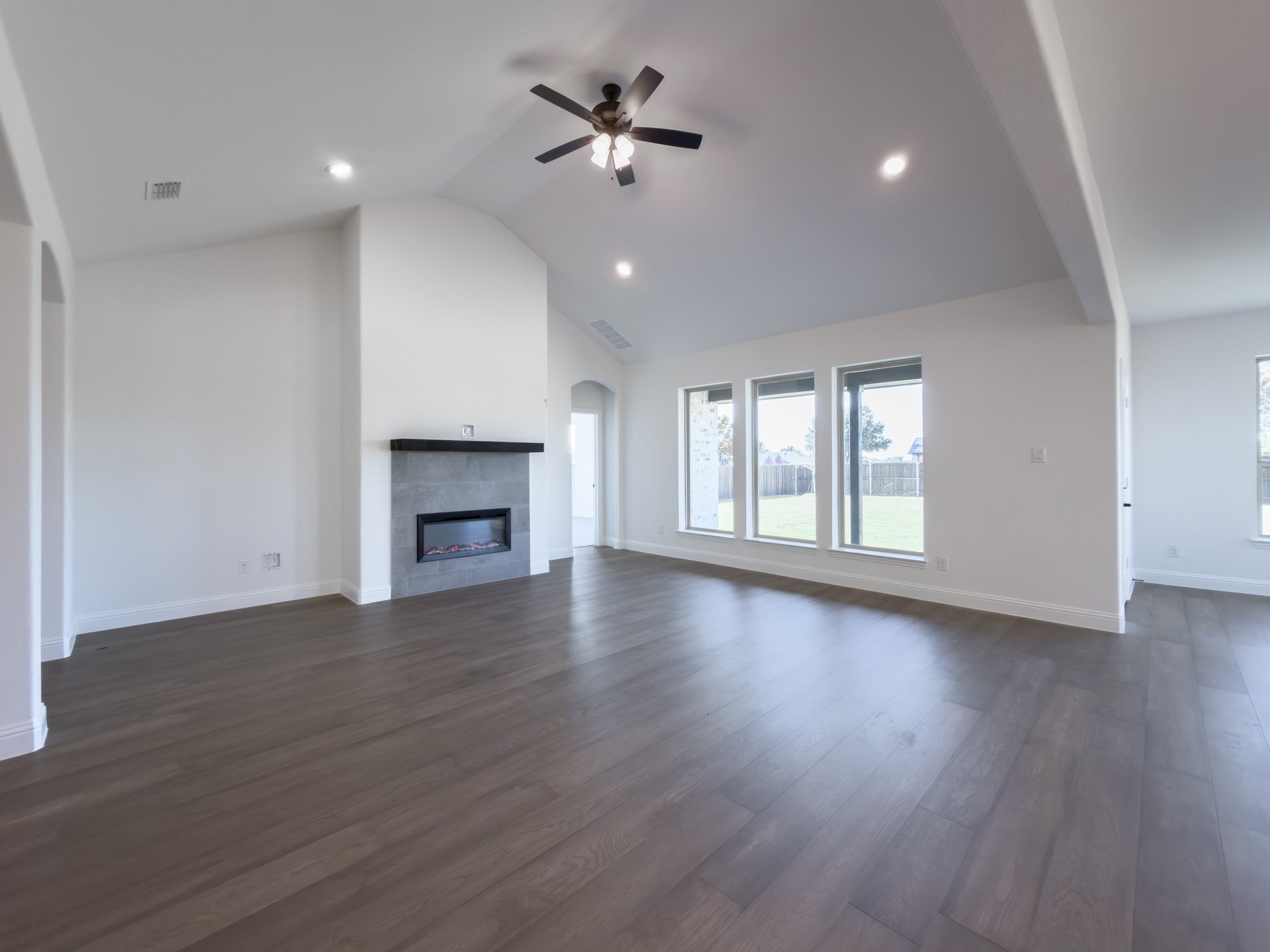 open great room with wood floors and fireplace