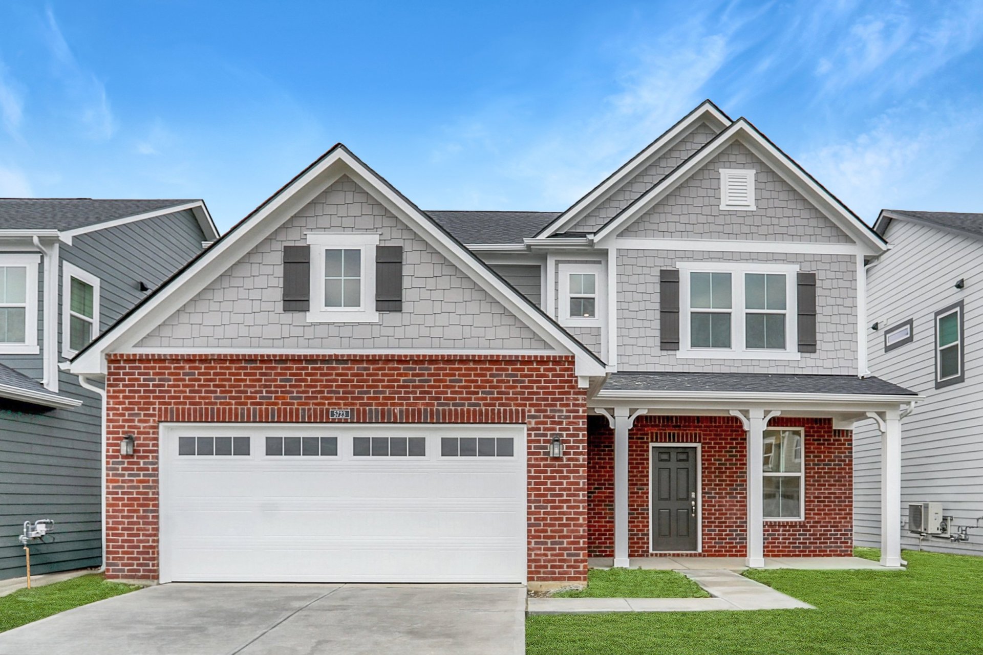 front exterior of the home with red brick and a covered front porch