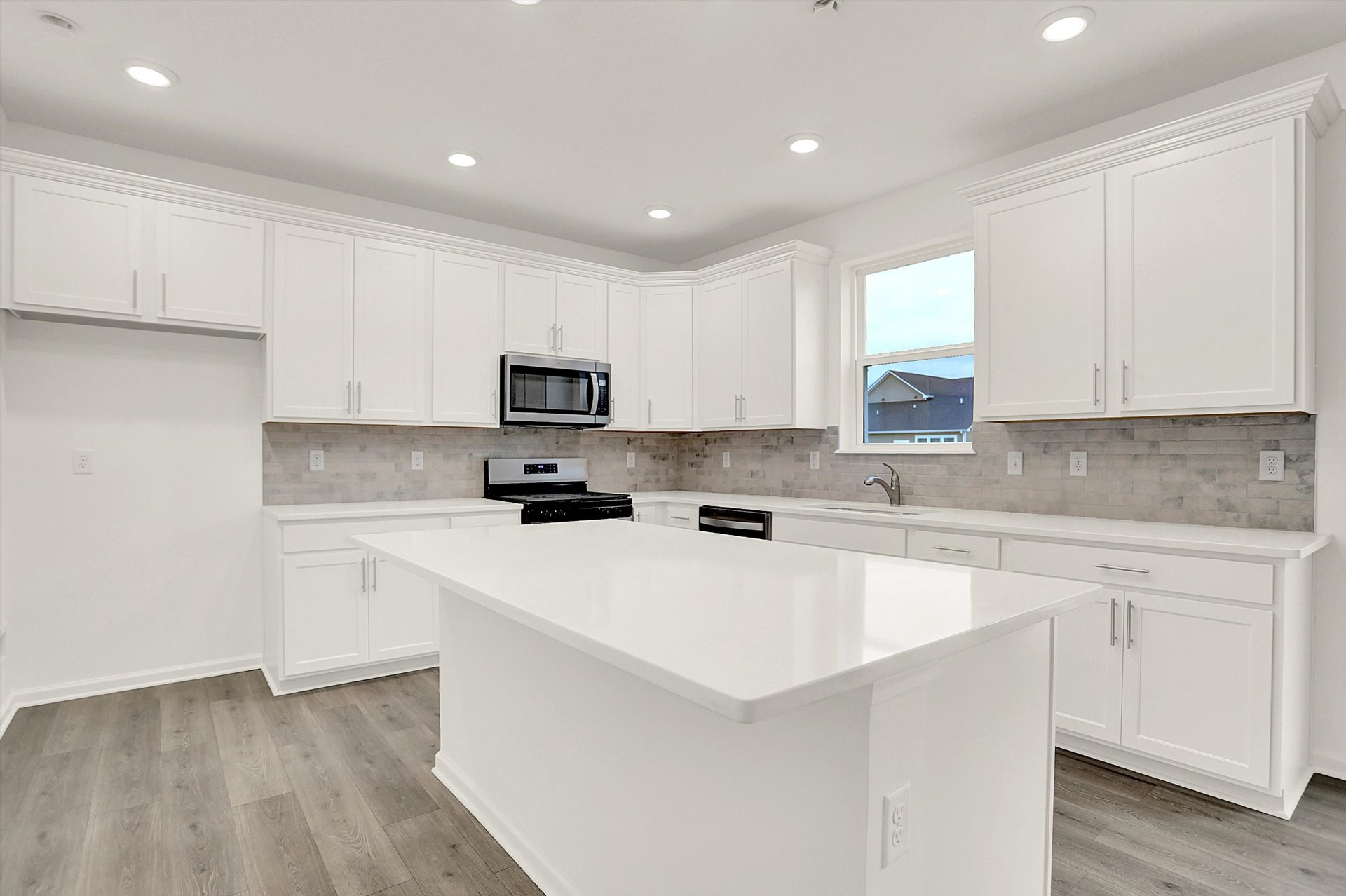 kitchen with white cabinets and tile backsplash