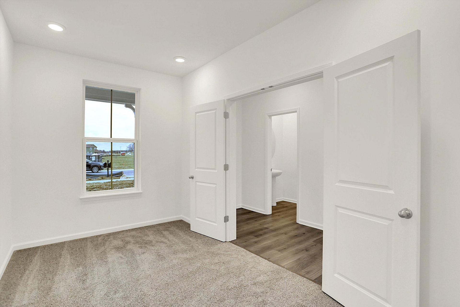 study with double doors and tan carpet