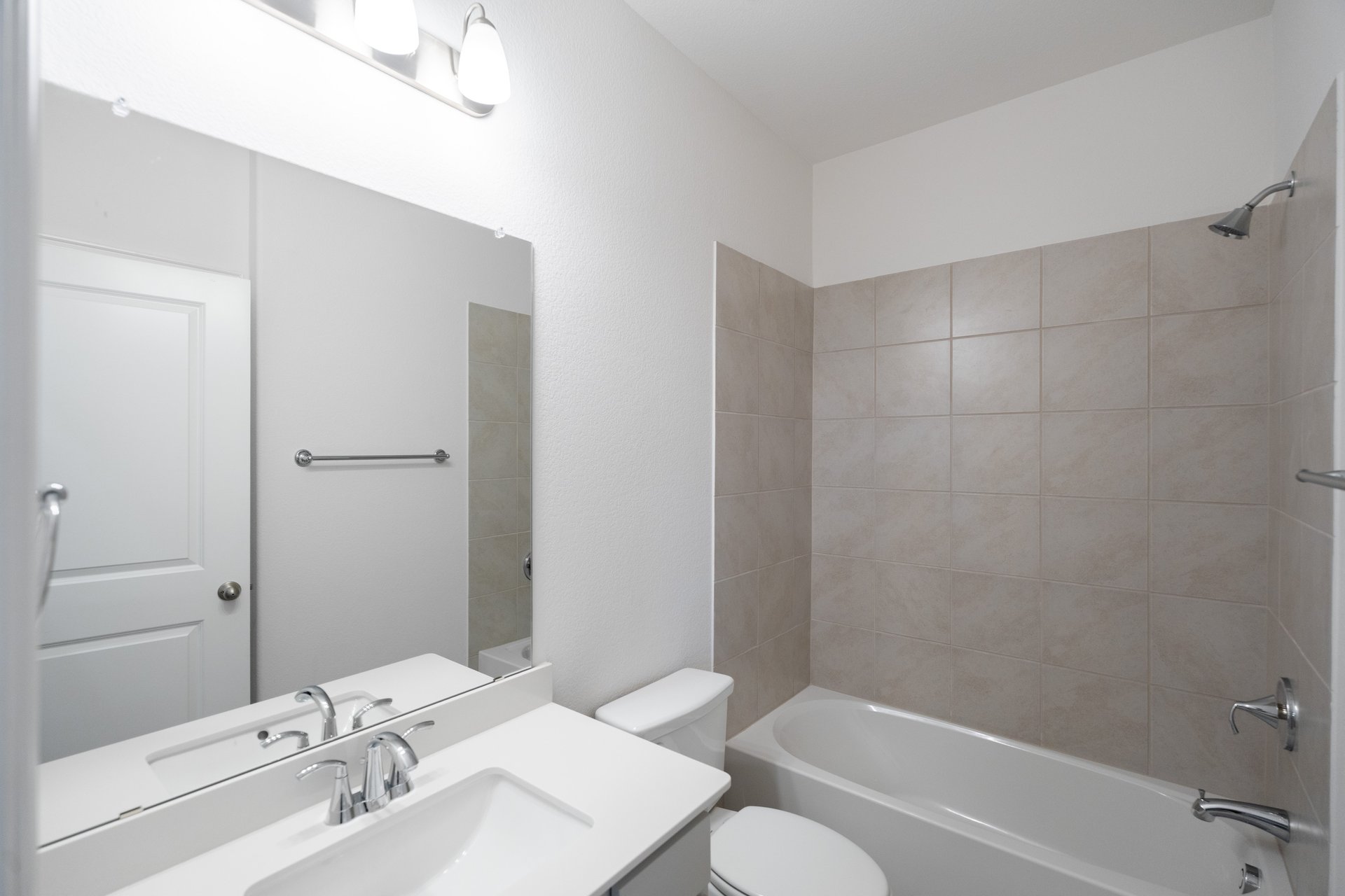 bathroom with tub and tile