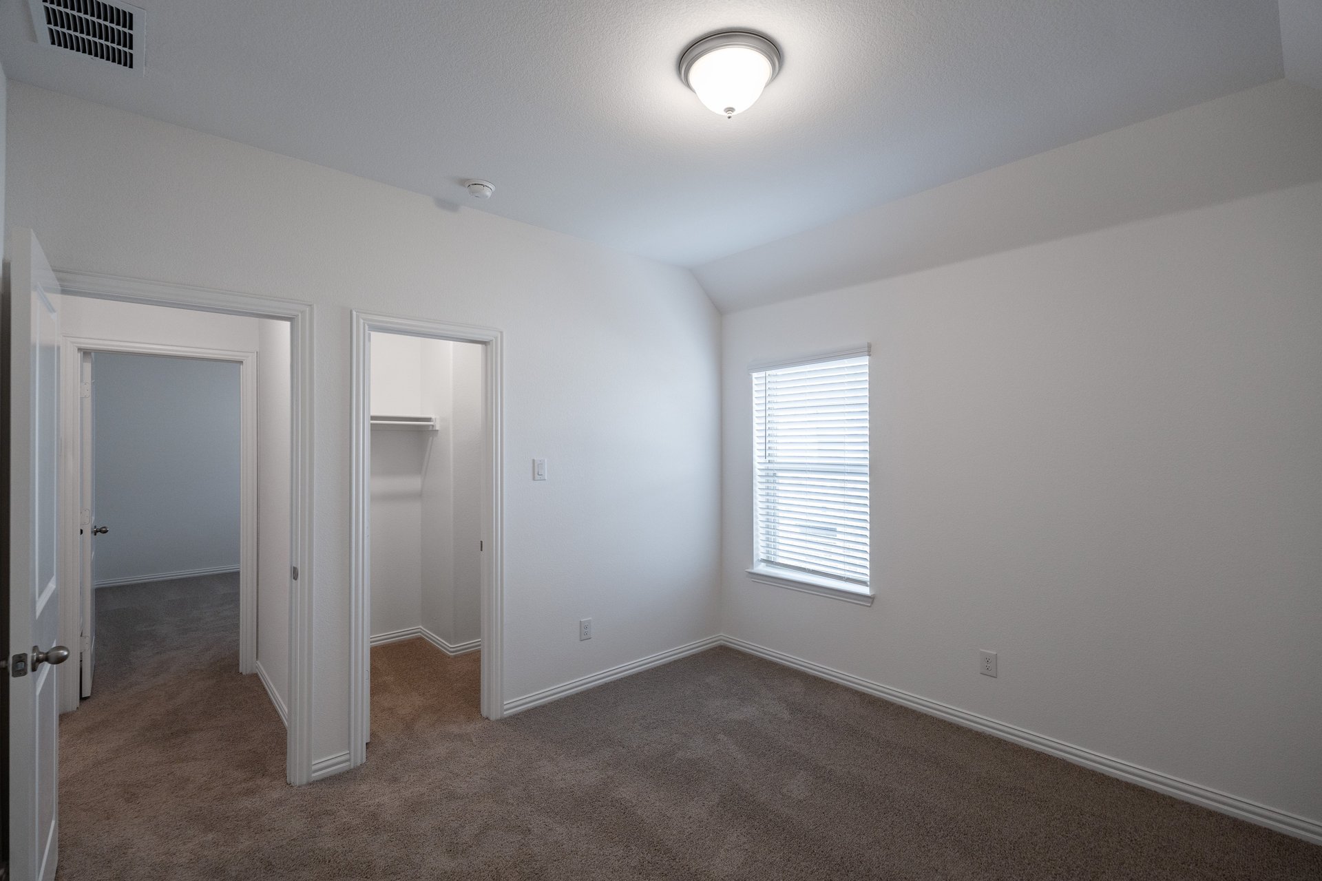 bedroom with carpet and window with blinds