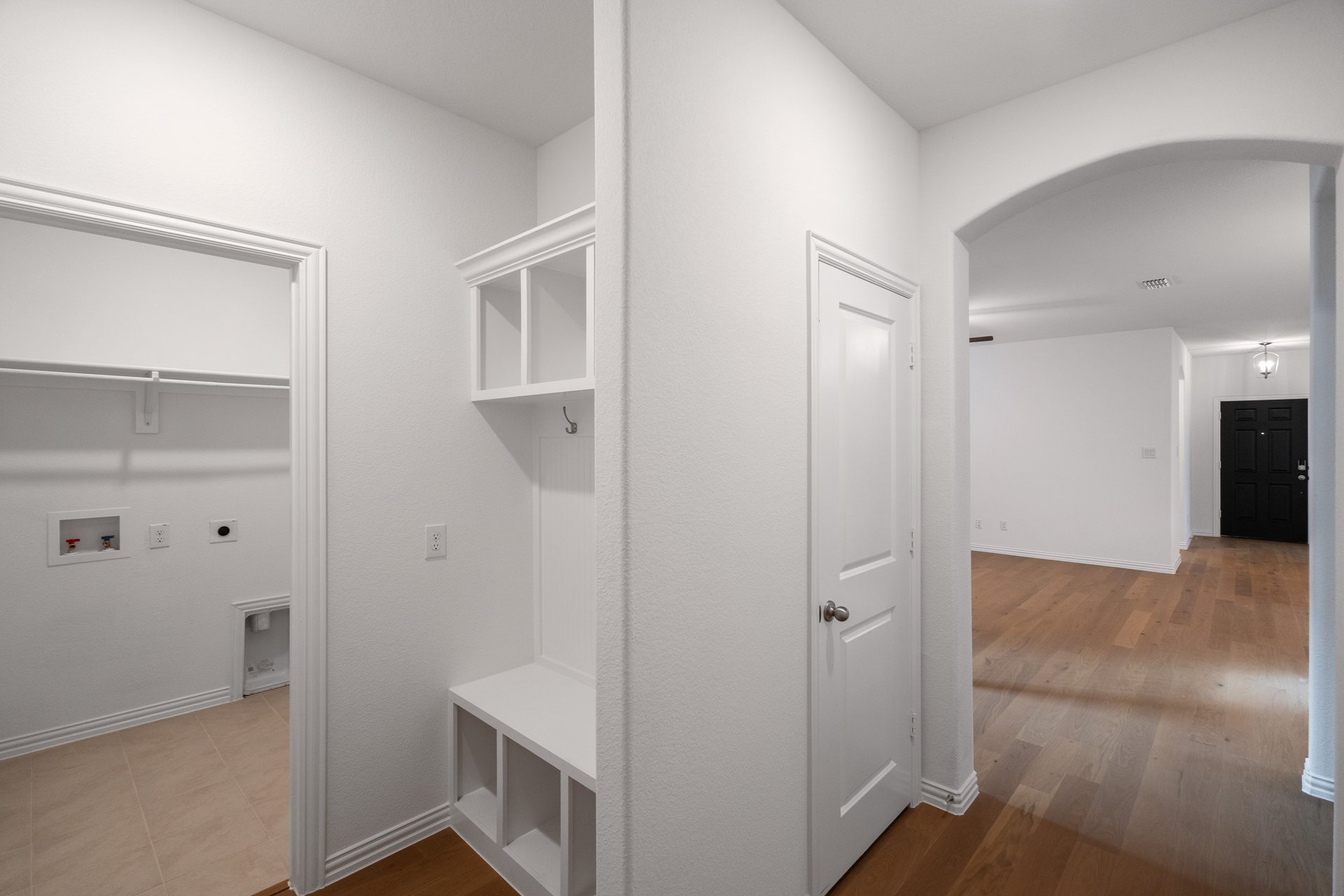 mudroom with cubby storage and next to laundry room