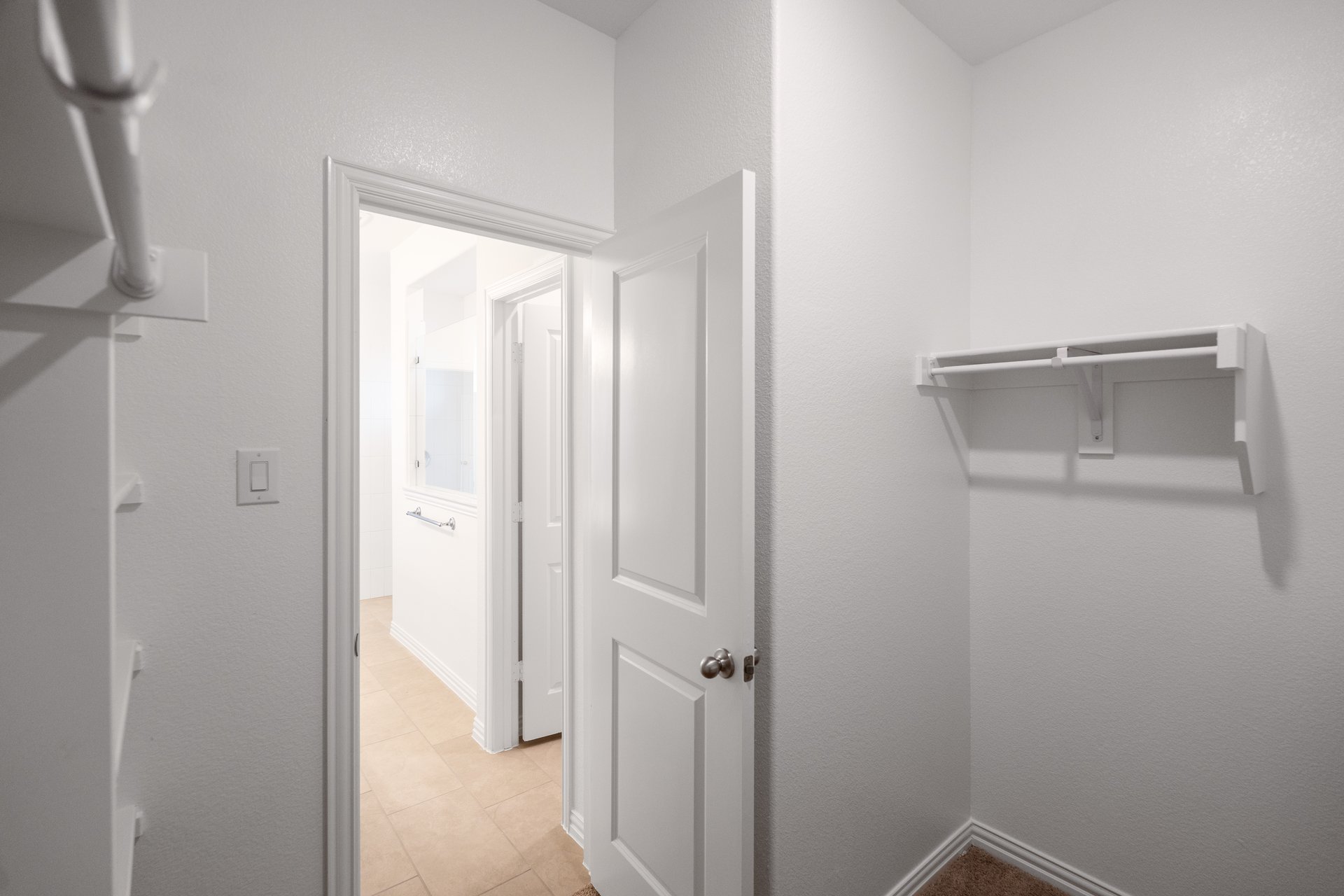 closet with hanging racks and shelves