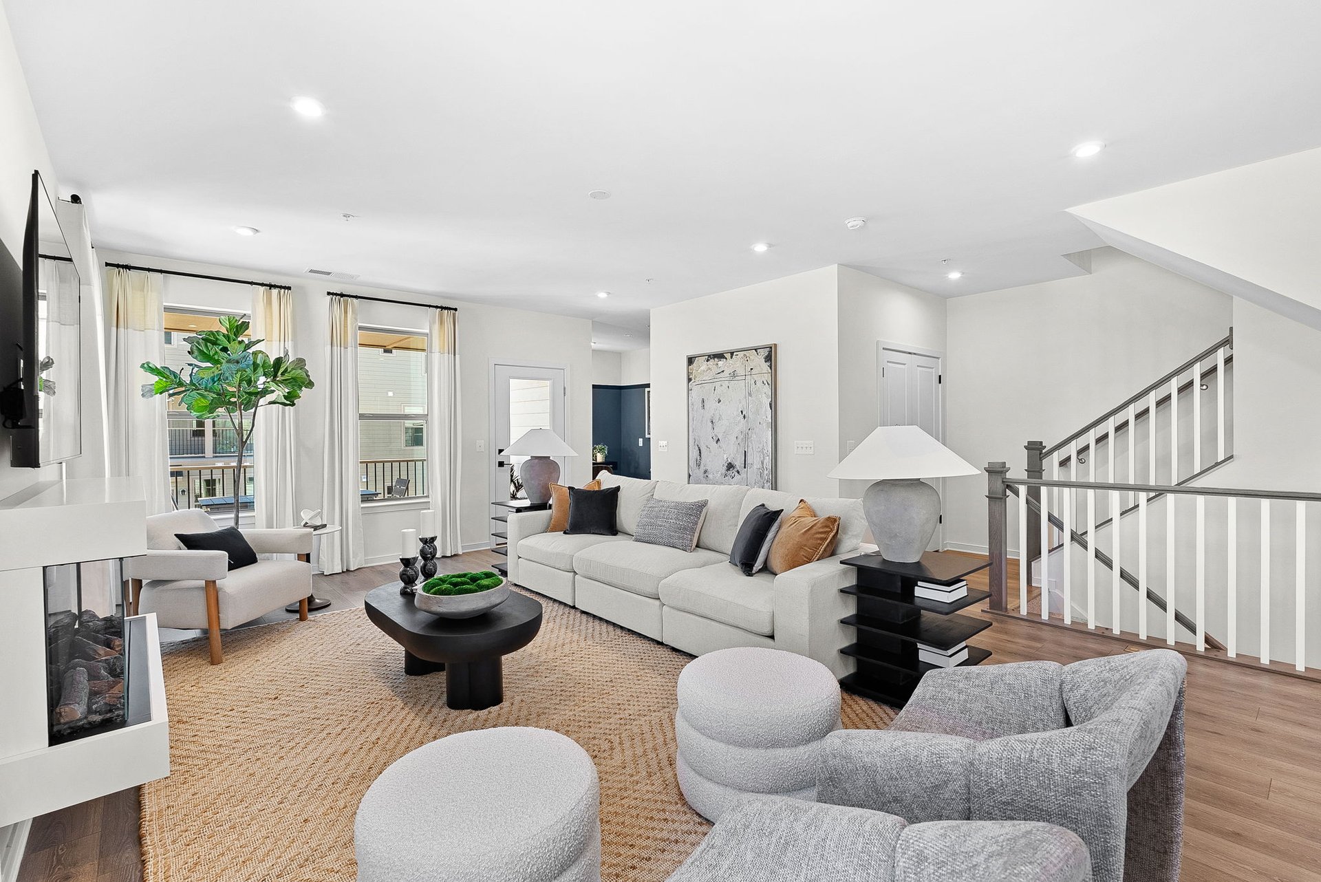 great room with a fireplace and access to the deck