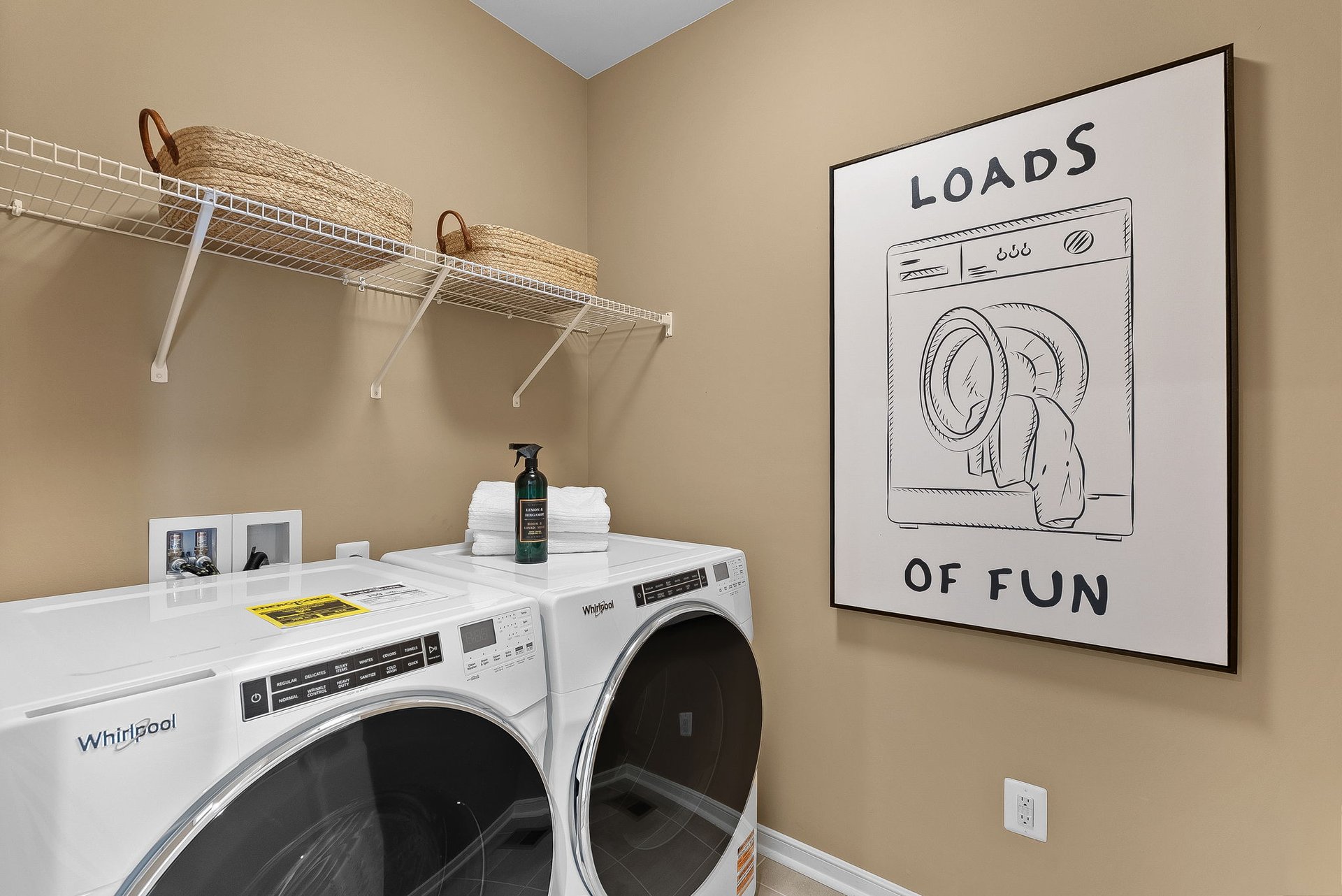 laundry room with a washer, dryer and a shelf