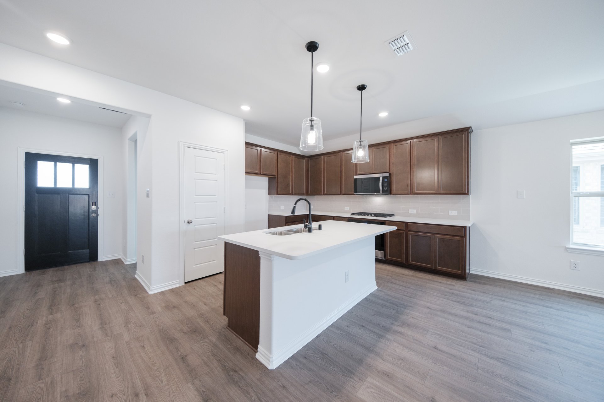 open kitchen with wood floors and island