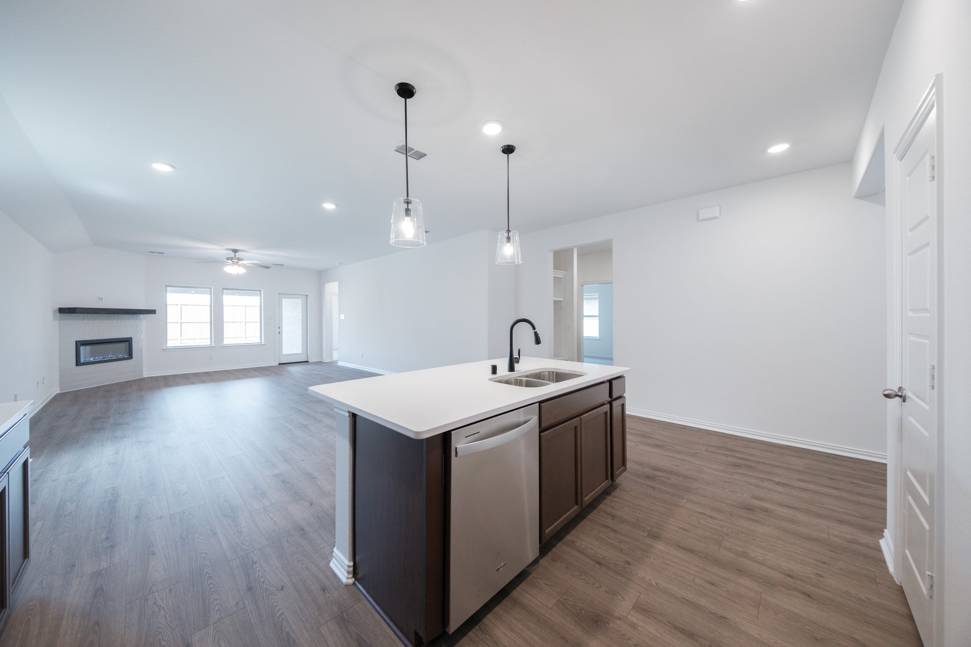 open kitchen with wood floors and island