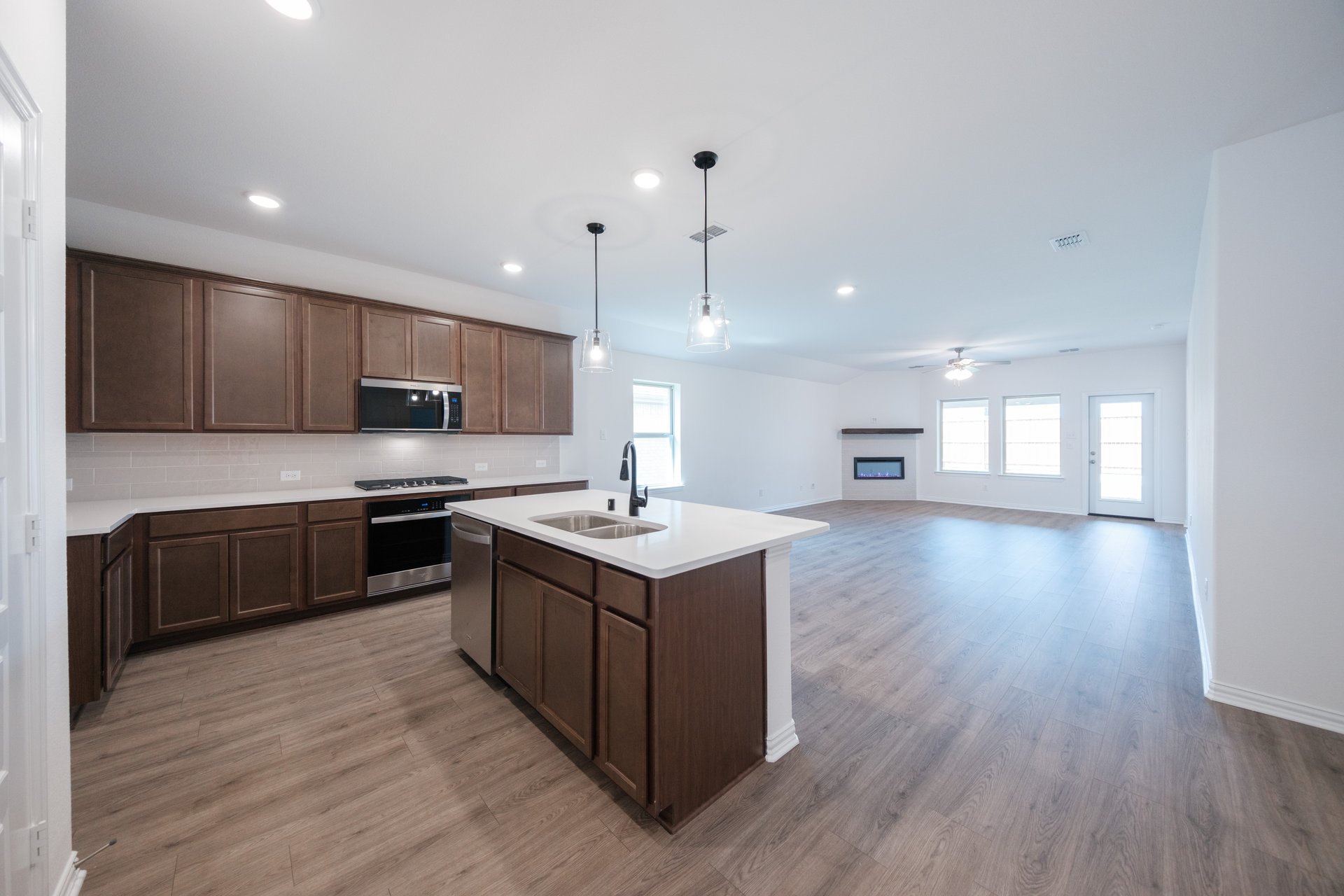 open kitchen with wood floors and island