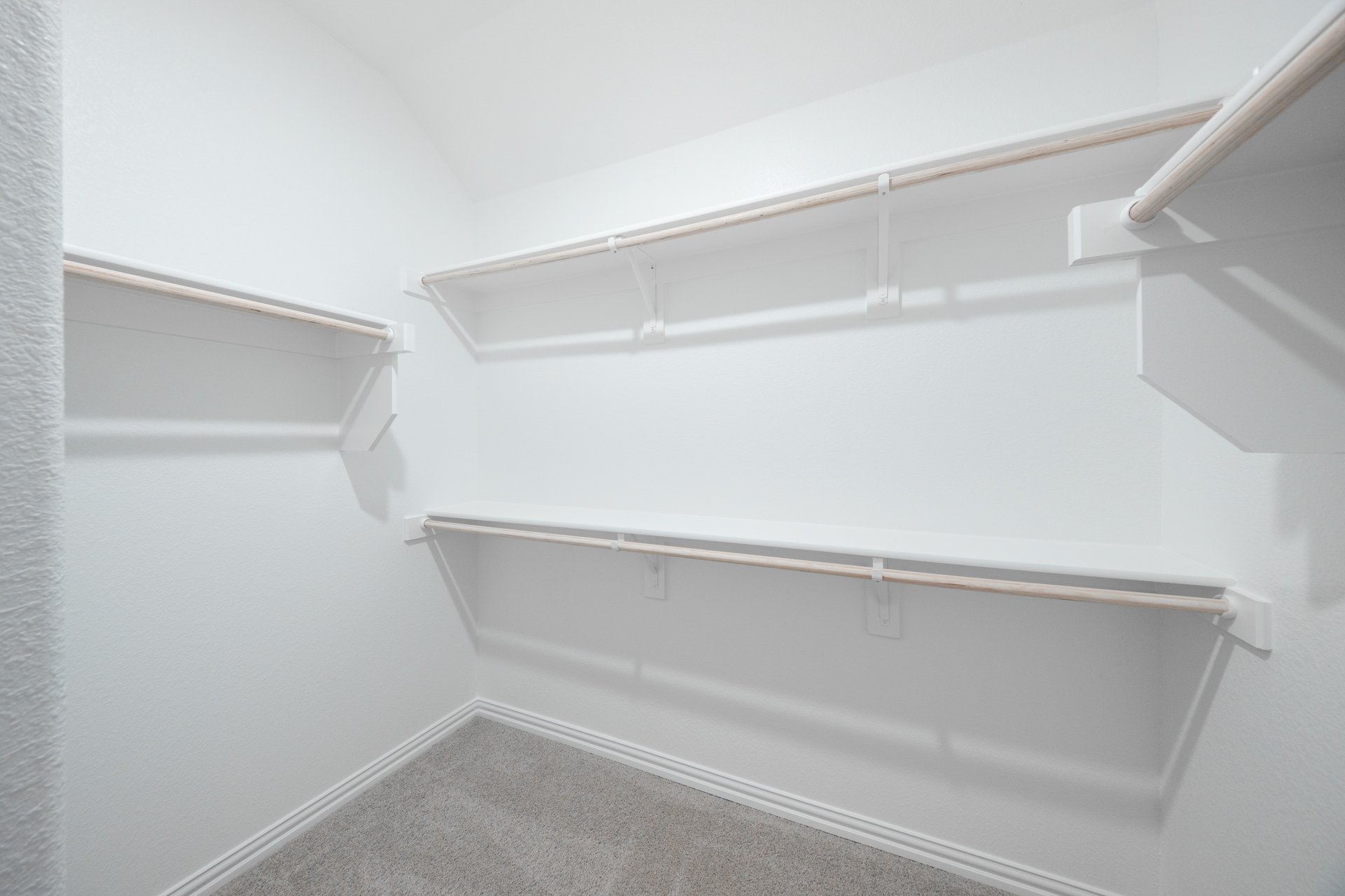 primary bedroom closet with carpet and white shelves