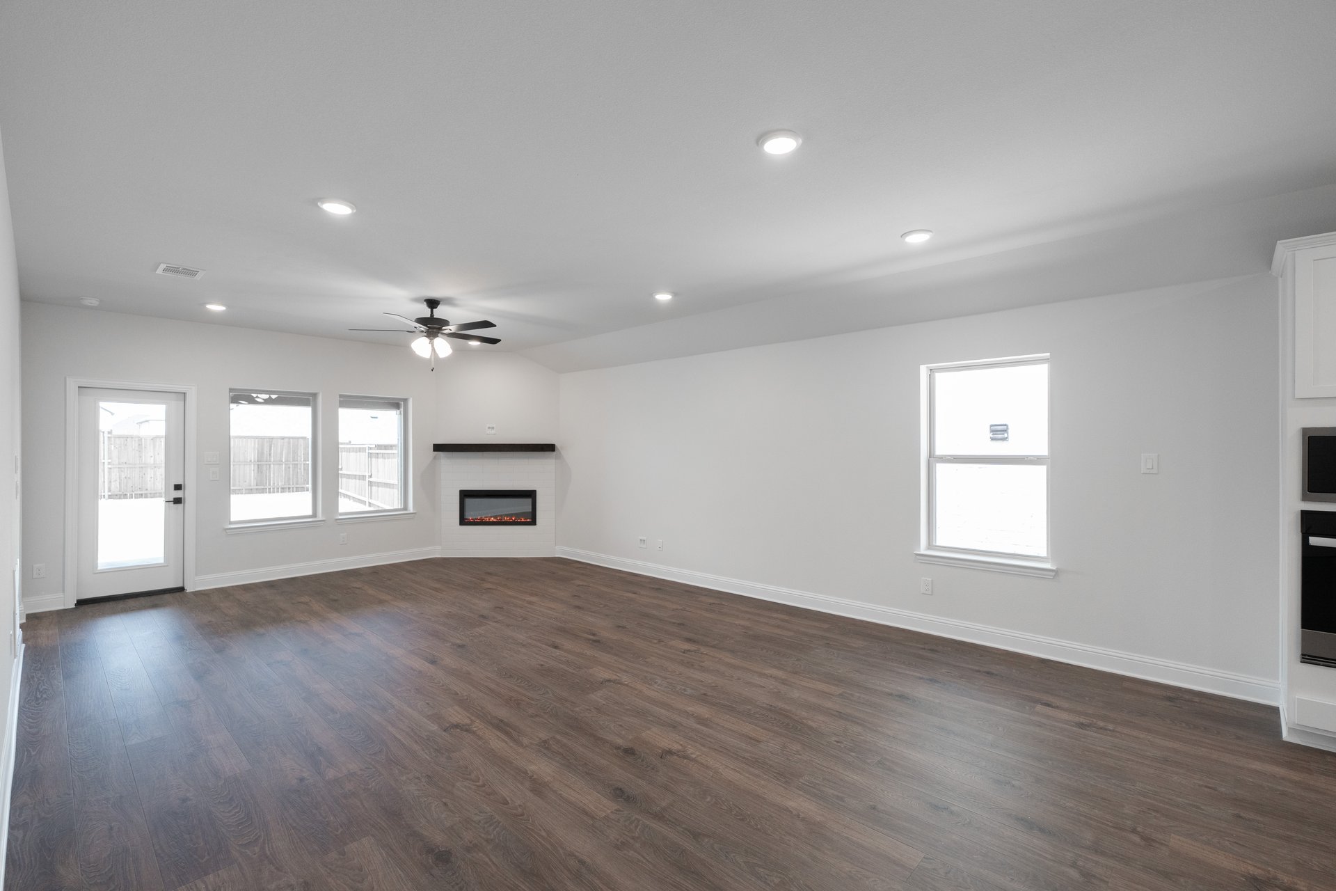 open great room with wood floors and fireplace