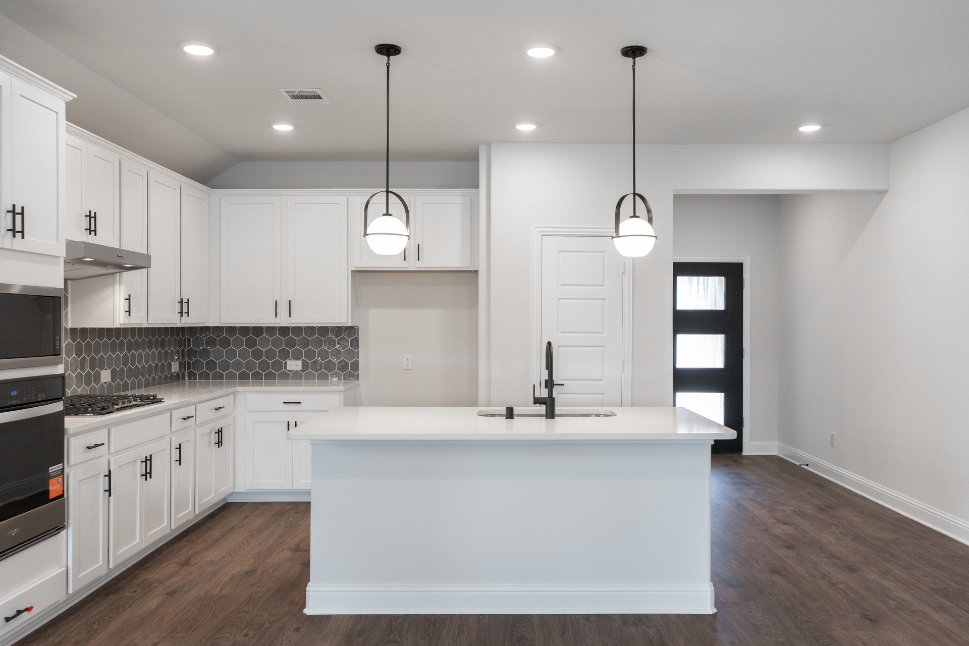 open kitchen with wood floors and island
