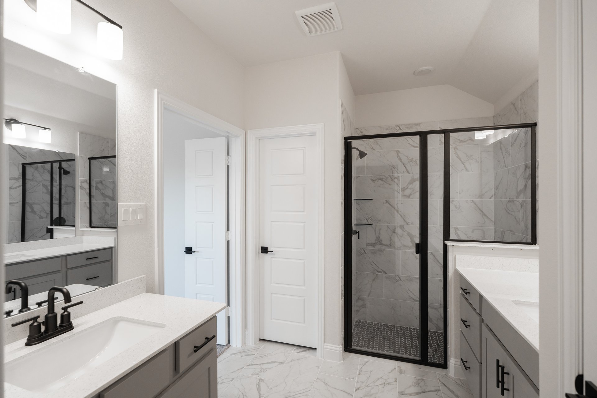 primary bathroom with walk-in shower and tile floors