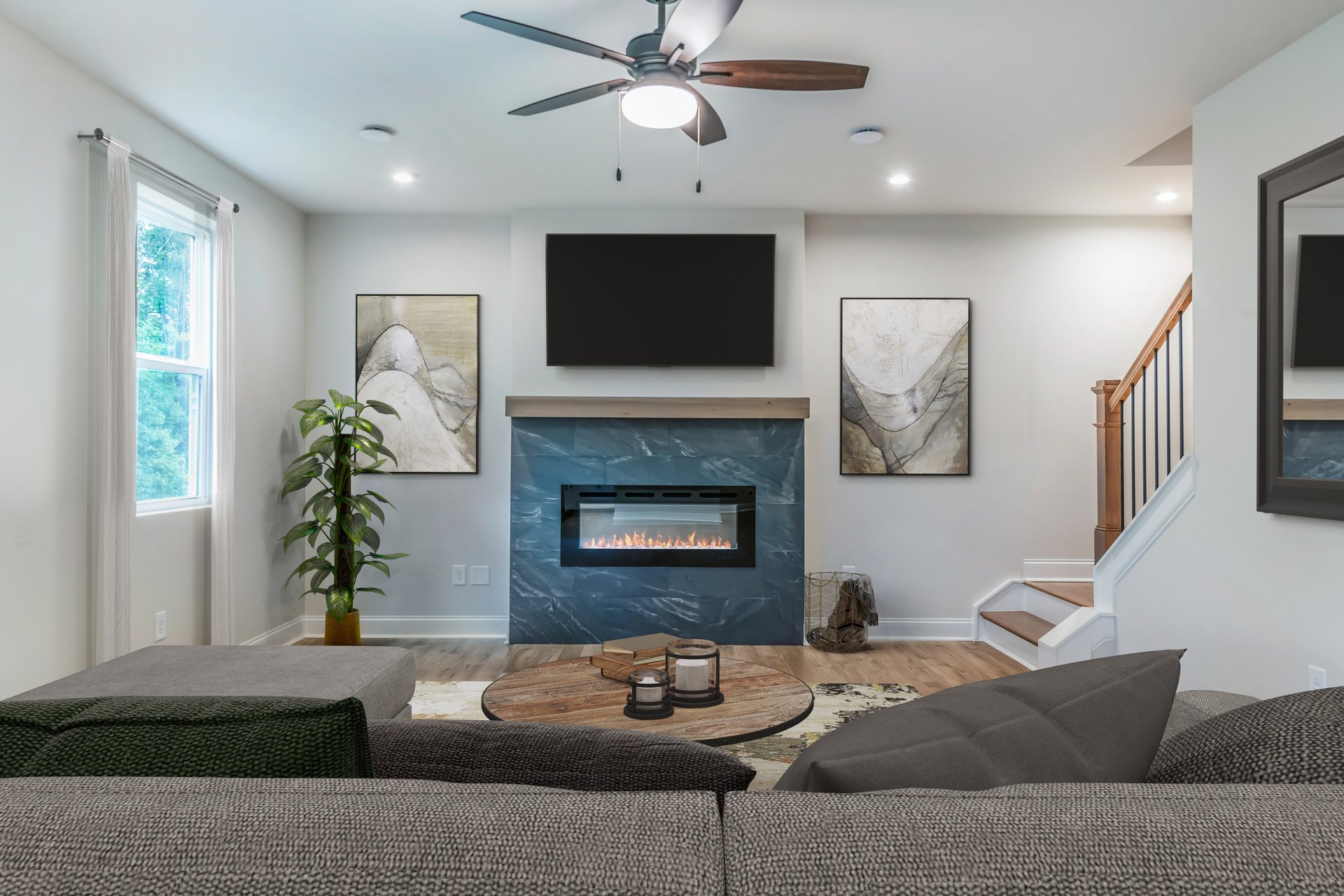 great room with electric fireplace and couch