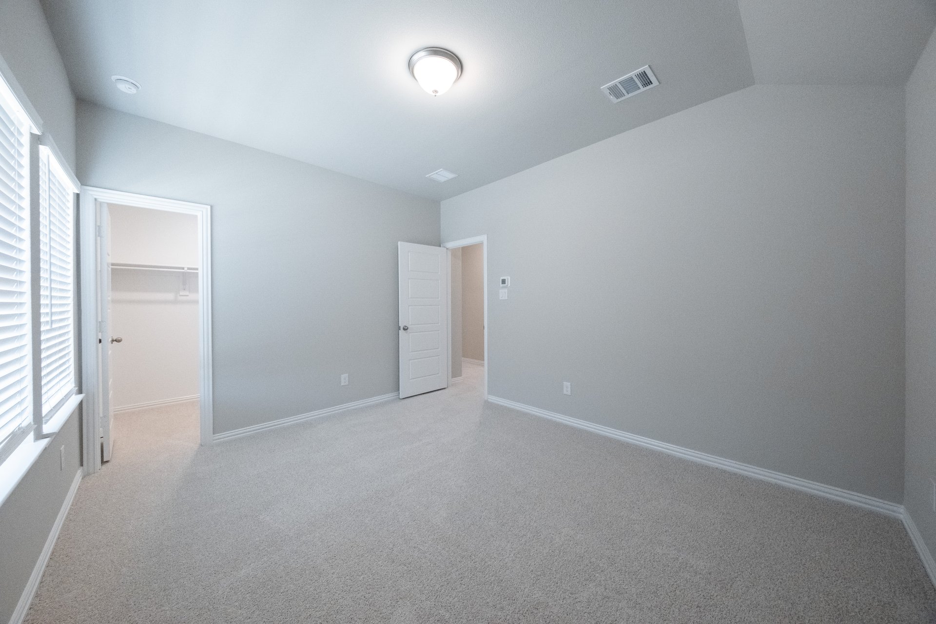 guest bedroom with carpet and walk-in closet