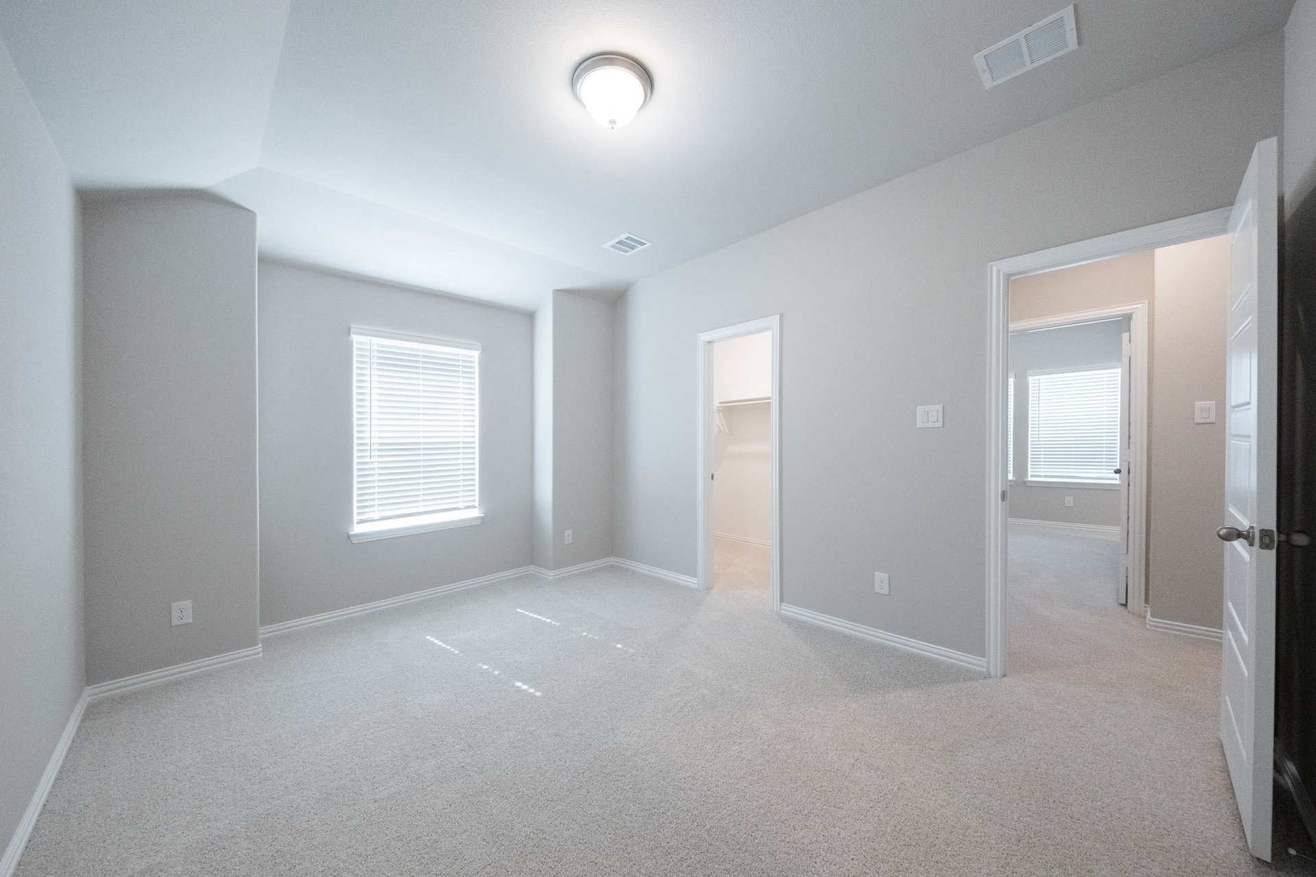guest bedroom with carpet and walk-in closet