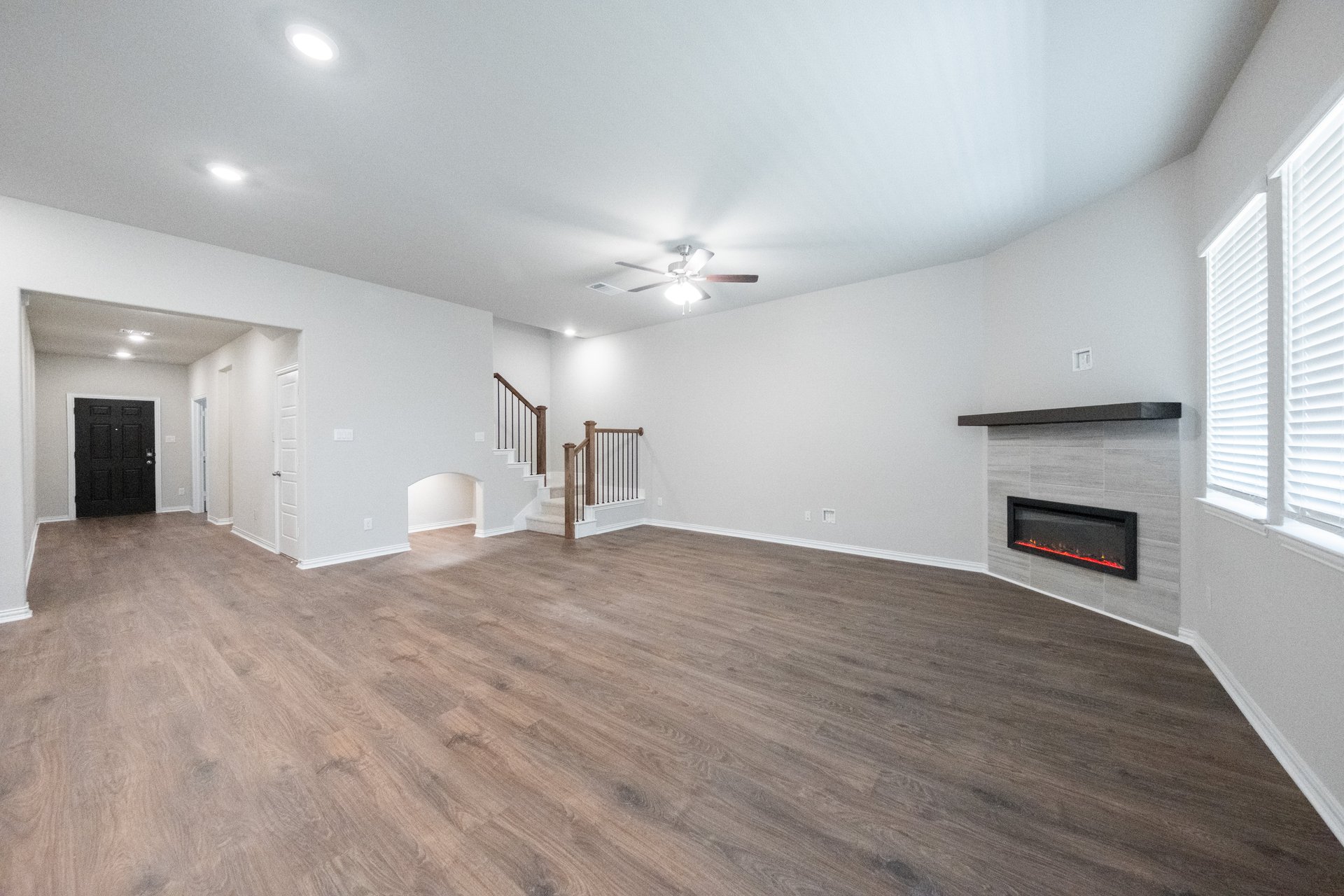 open great room with hardwood flooring and electric fireplace