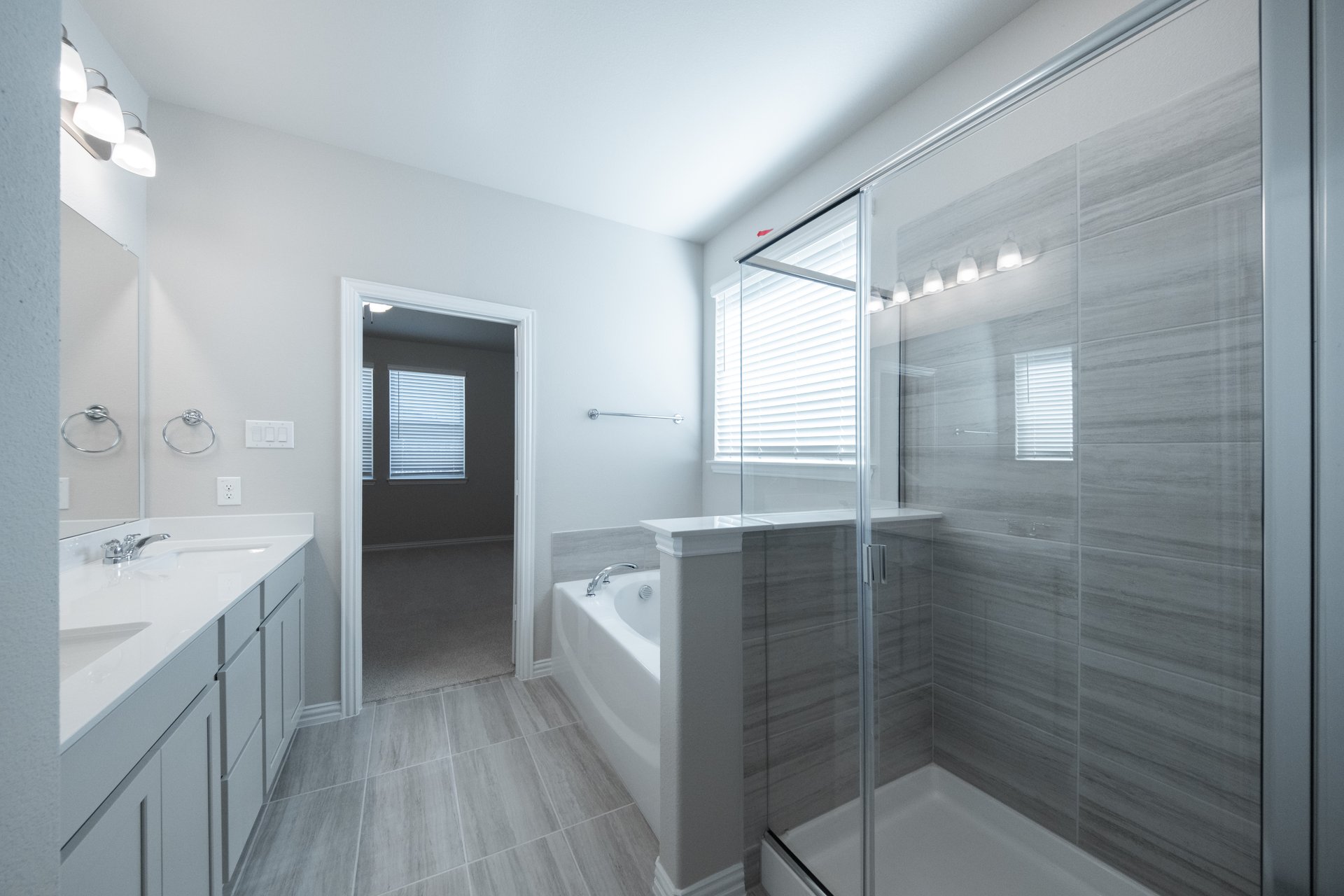 spacious primary bathroom with soaking tub and walk-in shower