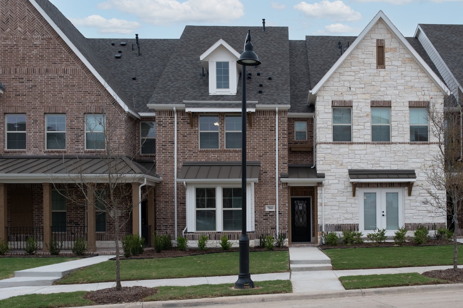 townhouse exterior with brick and landscaping