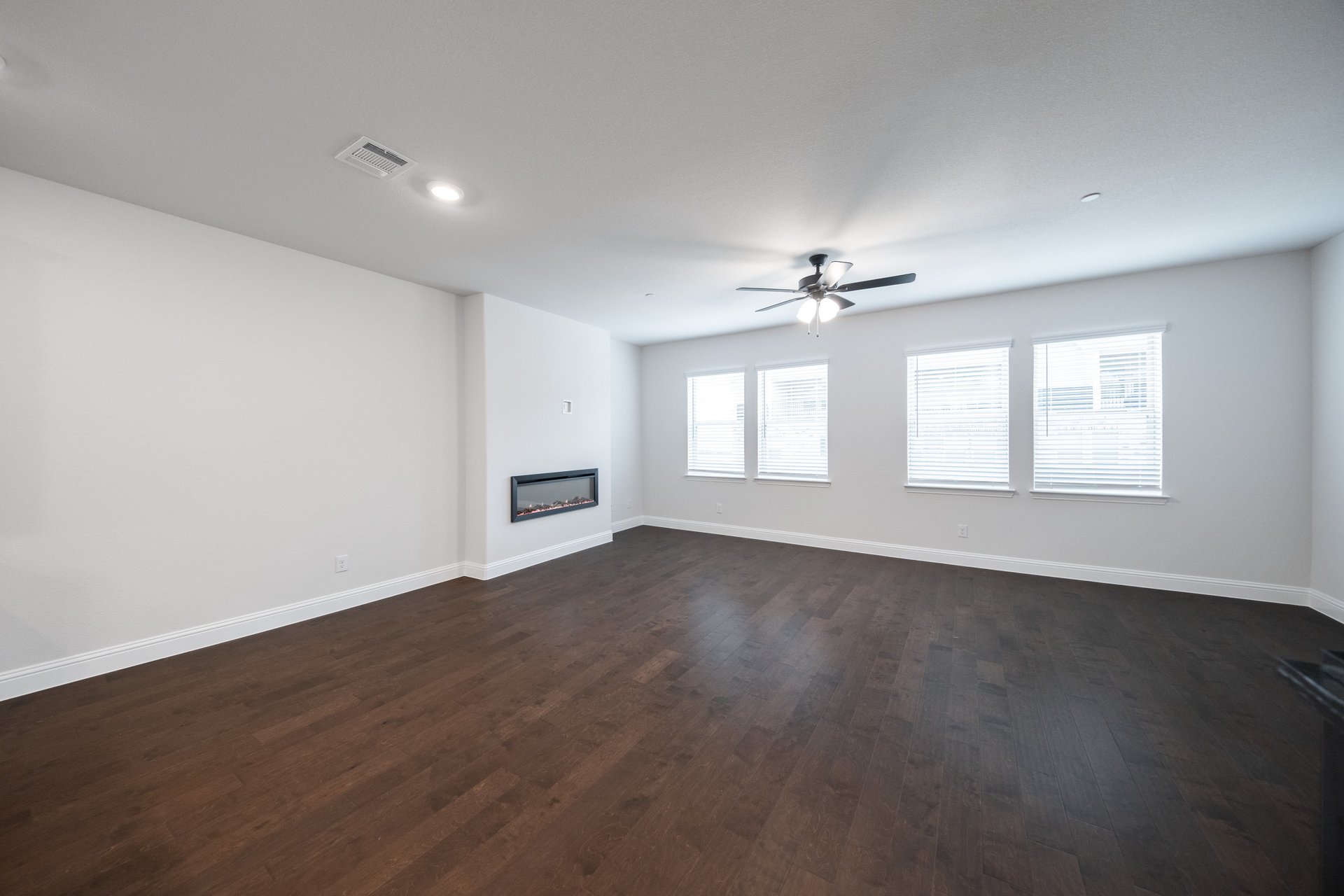 great room with wood flooring and fireplace