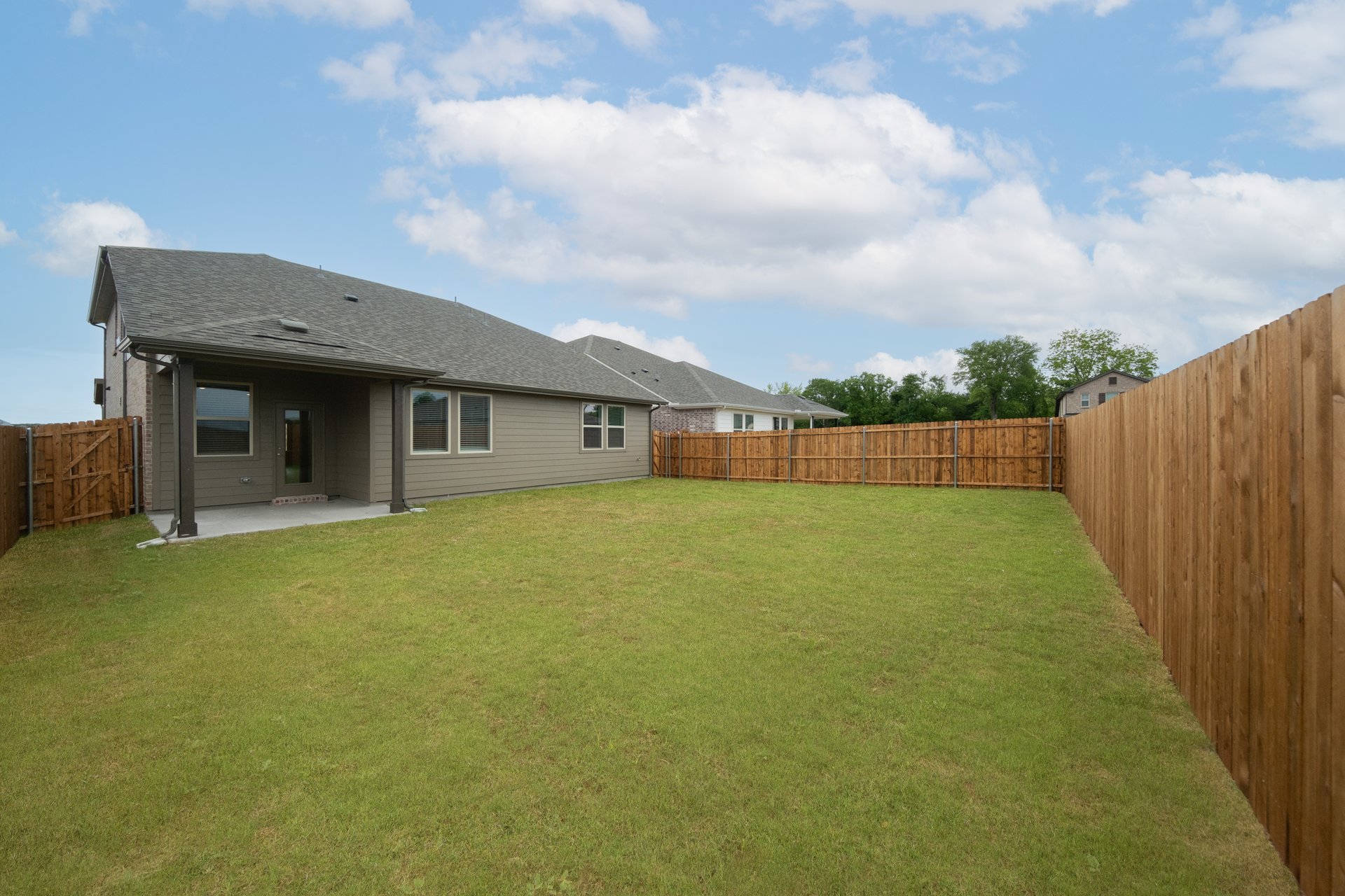backyard with grass and covered patio