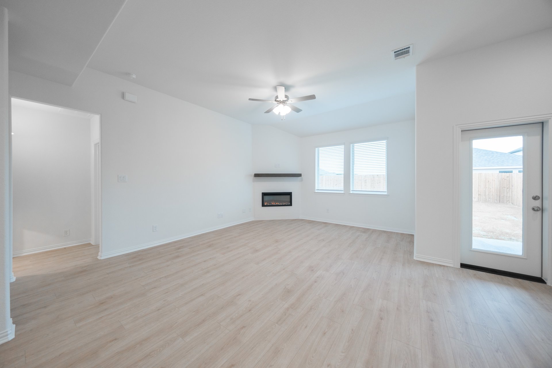 open great room with wood floors and fireplace