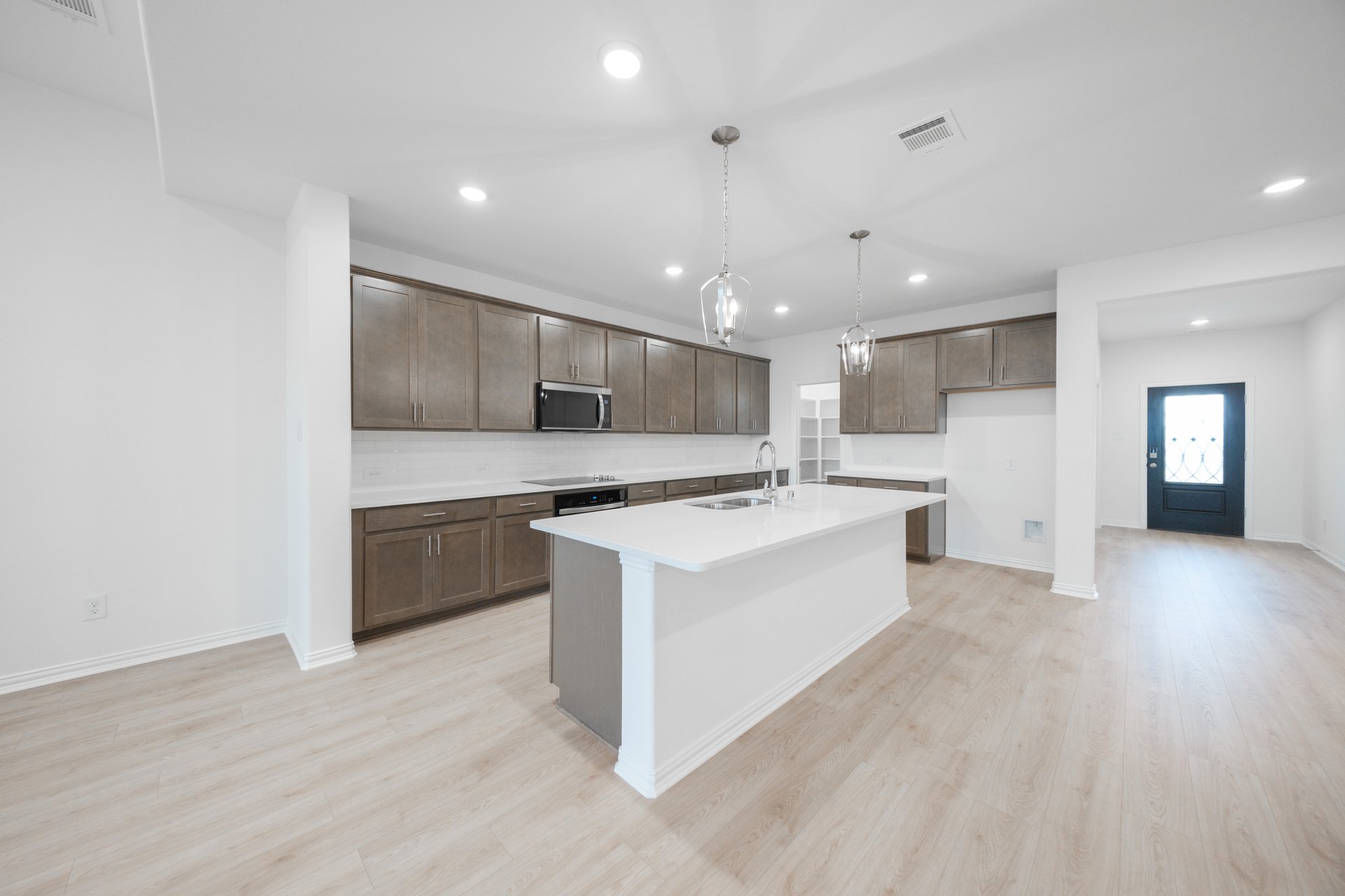 open kitchen with wood floors and island