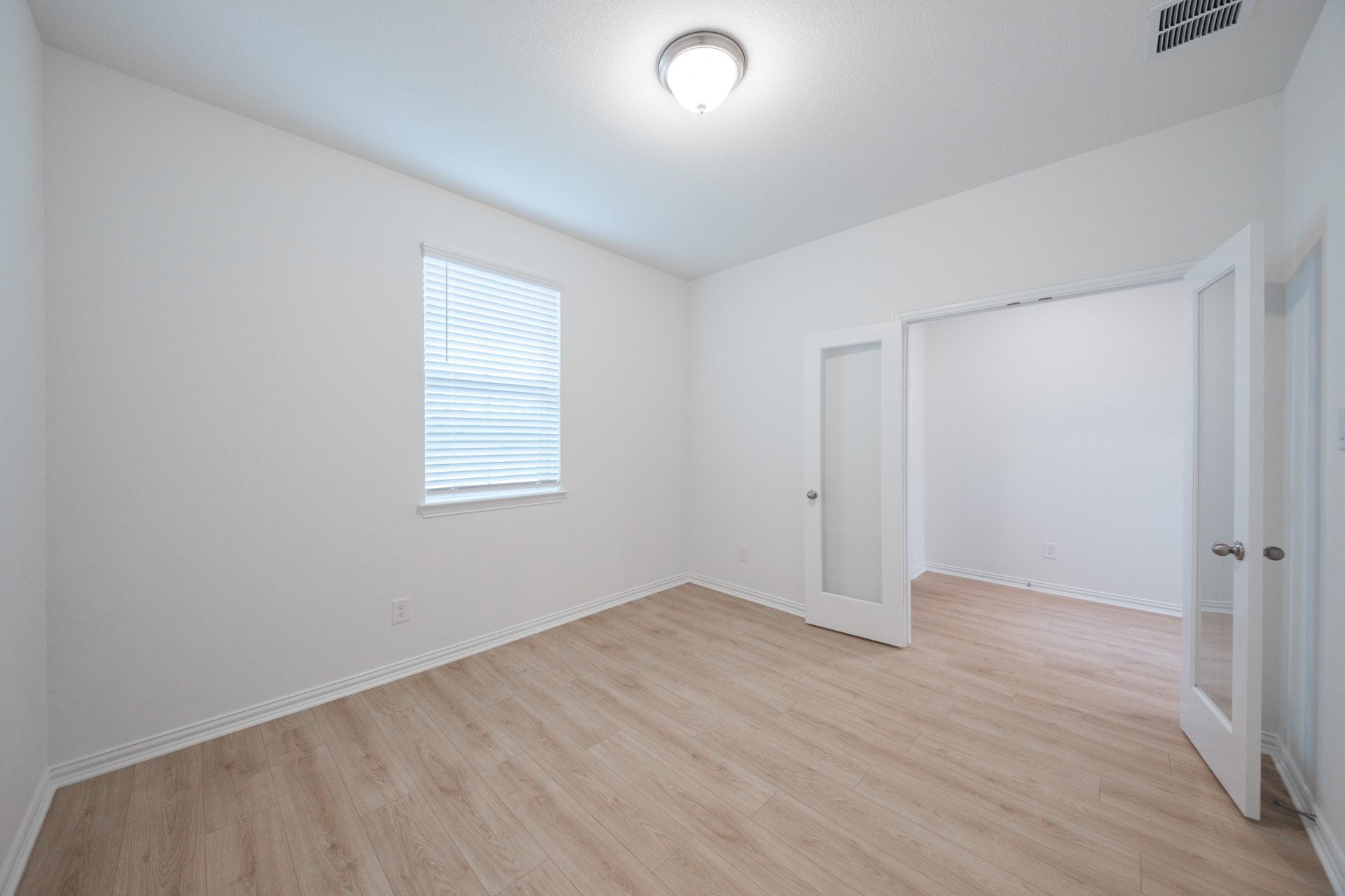private study with wood floors and french doors